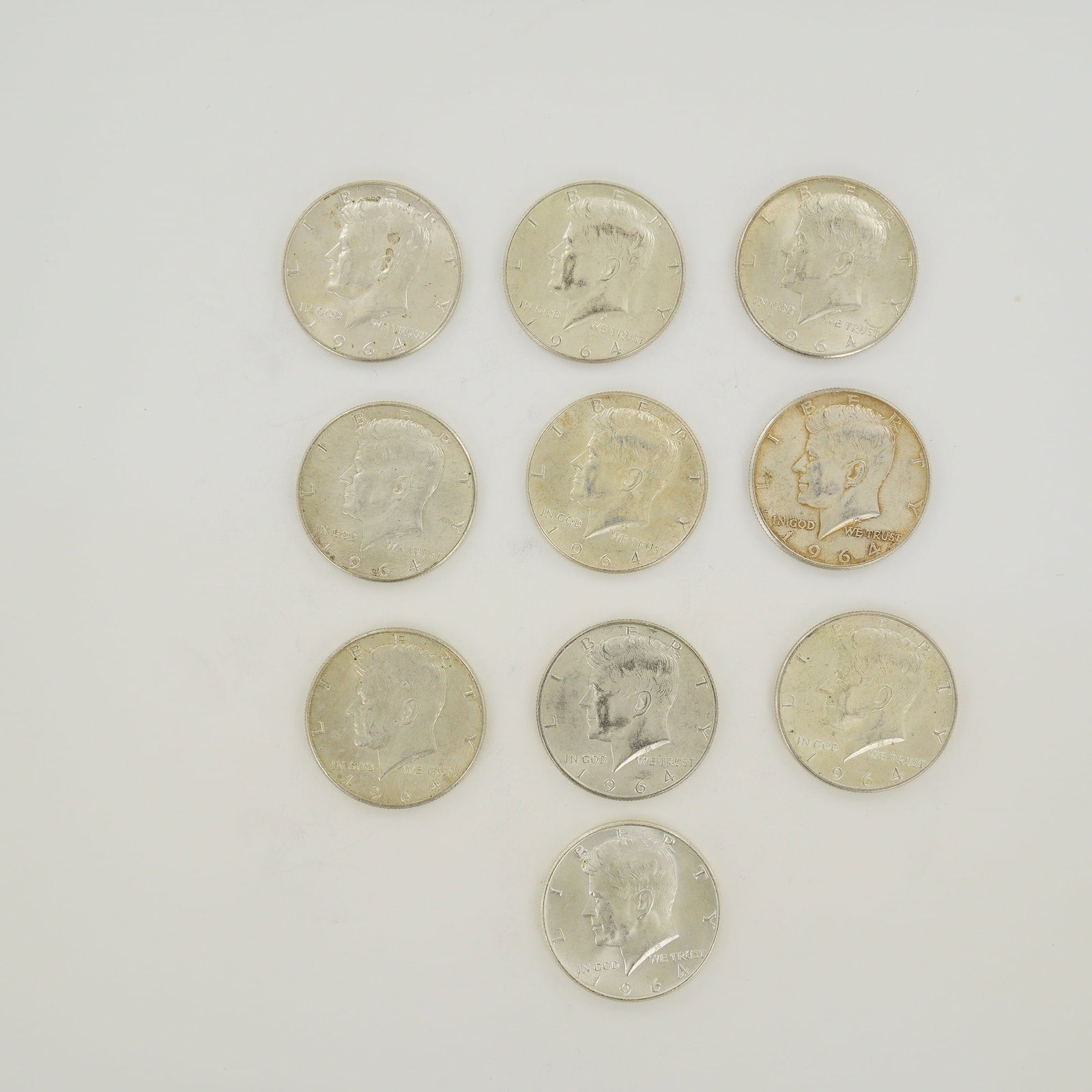 A Collection of Ten US 1964 Kennedy Half Dollars $5.00 Face Value: A collection of ten US 1964 Kennedy half dollars representing a $5.00 face value, cataloged as KM# 202. These coins are struck in .900 fine silver with a composition of 90 percent silver and 10 percen
