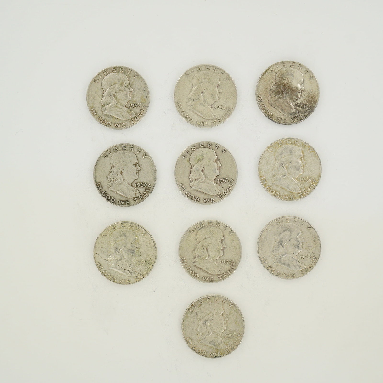 A Collection of US Ben Franklin 90% Silver Half Dollars, 1952-1963-D: A collection of US Benjamin Franklin half dollars struck in 90% silver. The group includes specimens dated 1952, 1954, 1957, 1959, 1960, and 1963. Each coin features the D mint mark on the reverse abo