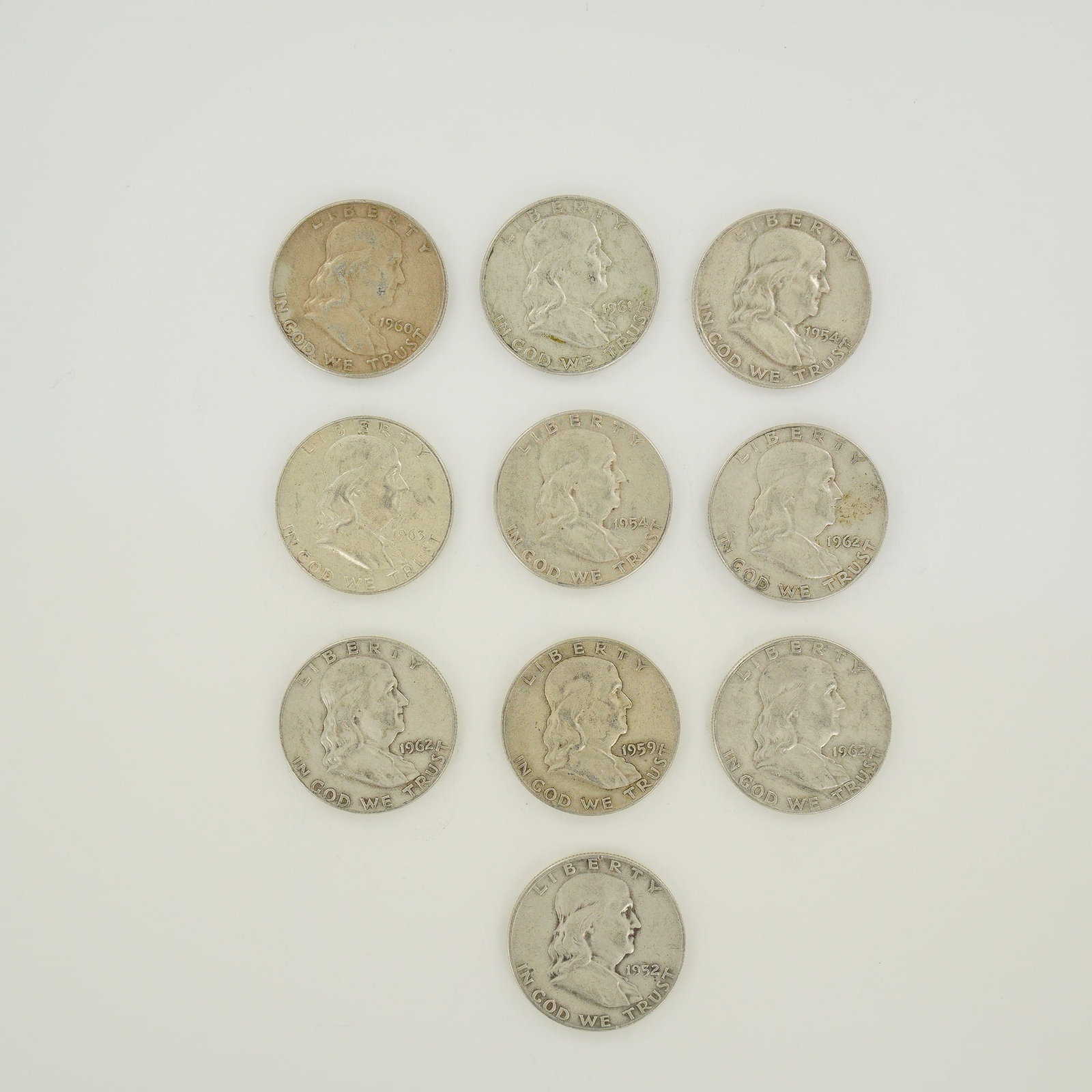 A Collection of US Ben Franklin Half Dollars: A collection of US Ben Franklin half dollars struck in 90% silver. This group consists of coins produced at the Philadelphia, Denver, and San Francisco mints. The assortment includes the following dat