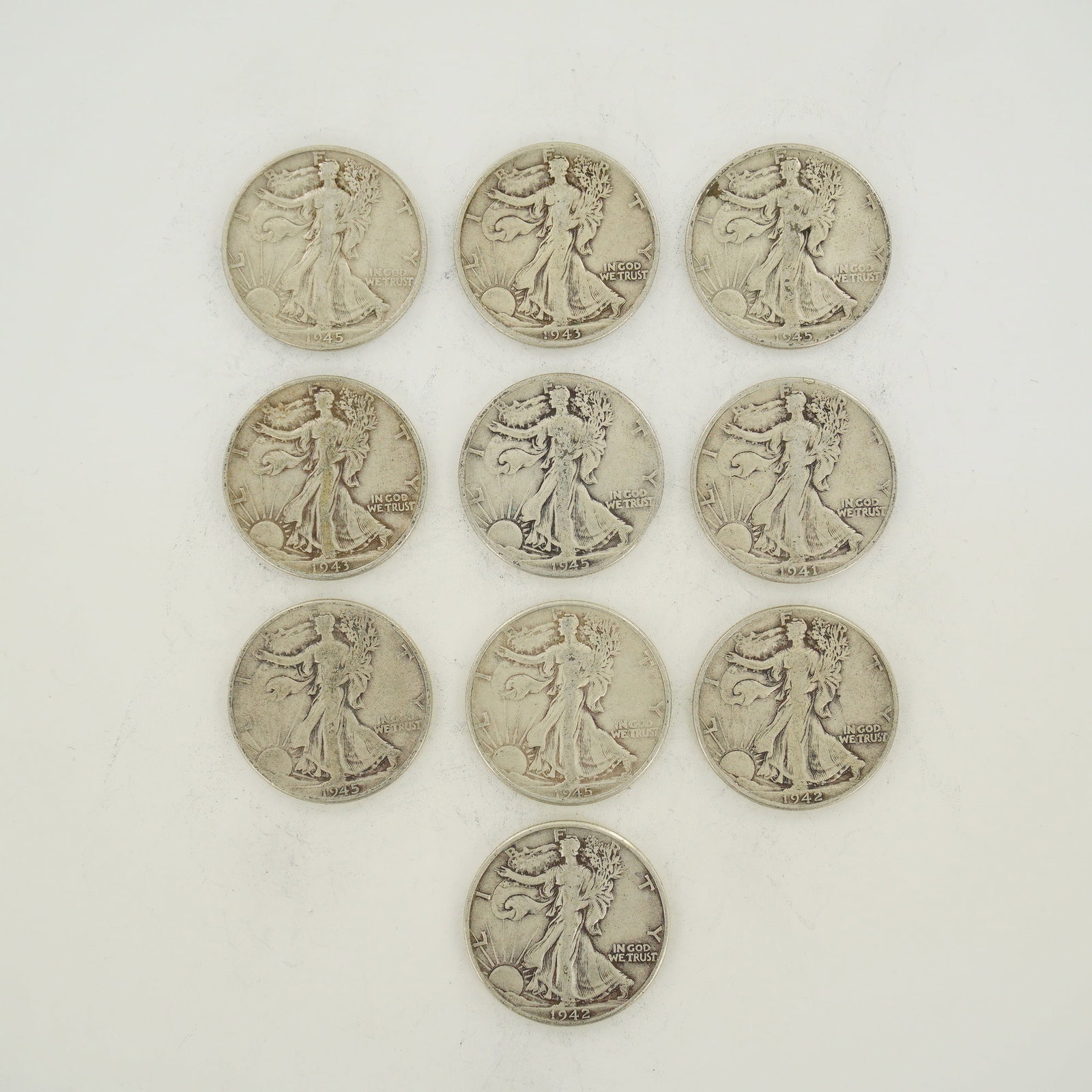 A Collection of US Walking Liberty Half Dollars Mixed Date Bag: This collection of US Walking Liberty half dollars consists of a mixed date bag of 90 percent silver coins. The group includes specimens dated 1941, 1942, 1943, and 1945. All coins feature the