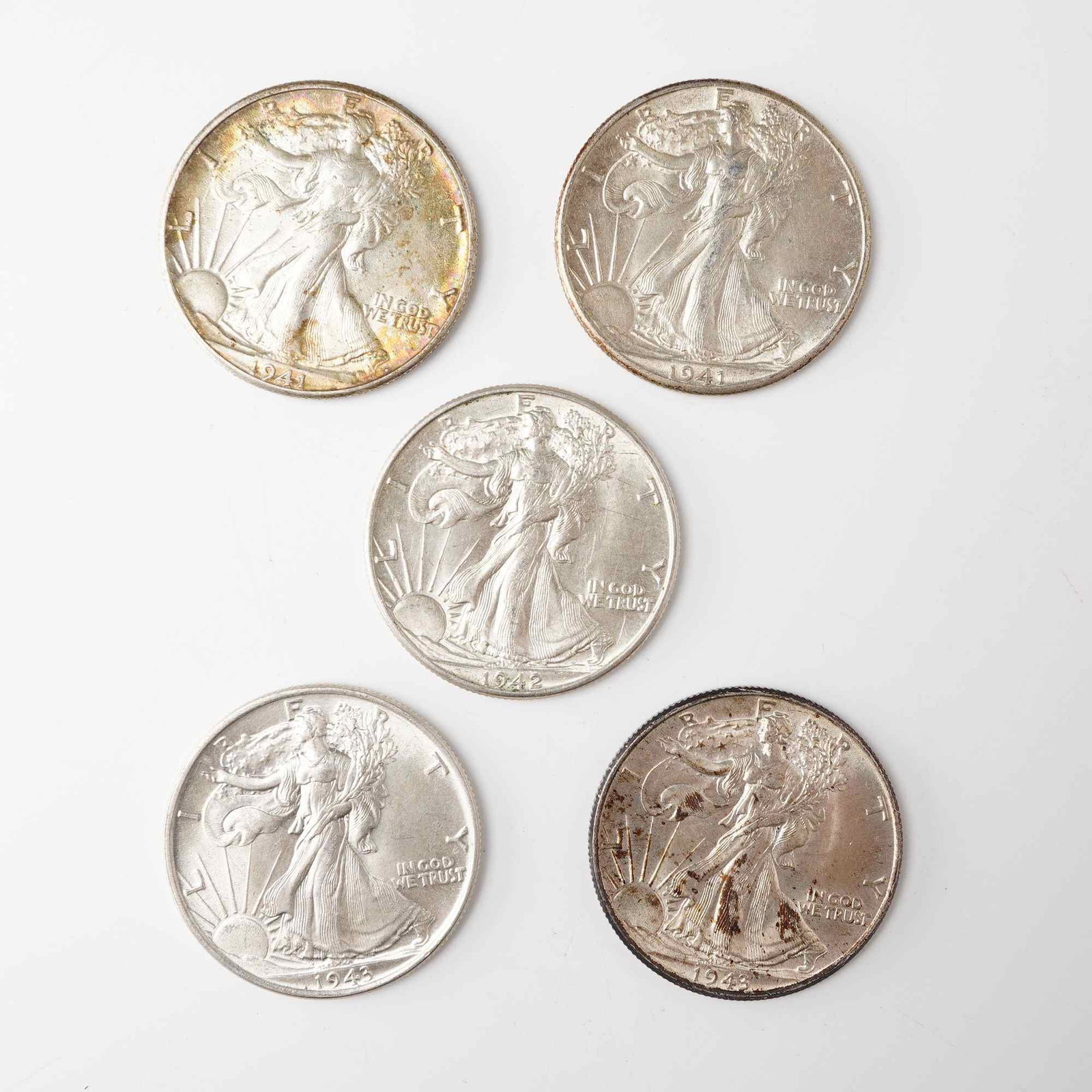 5pc 1941-1943 Walking Liberty Half Dollar Coins: Each coin is composed of .900 silver and includes the years 1941, 1942, and 1943. Each obverse displays Adolph Alexander Weinman's allegorical figure of Liberty striding toward the dawn draped in the 