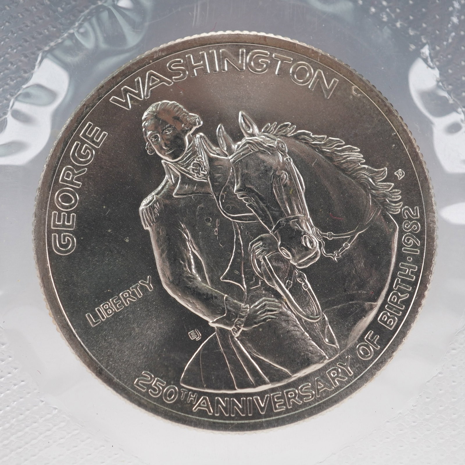 1732 - 1982-D George Washington Commemorative Silver Half Dollar: United States Mint 1732-1982-D George Washington commemorative silver half dollar, struck to mark the 250th anniversary of Washington's birth. This uncirculated coin is presented in its original U.S. 