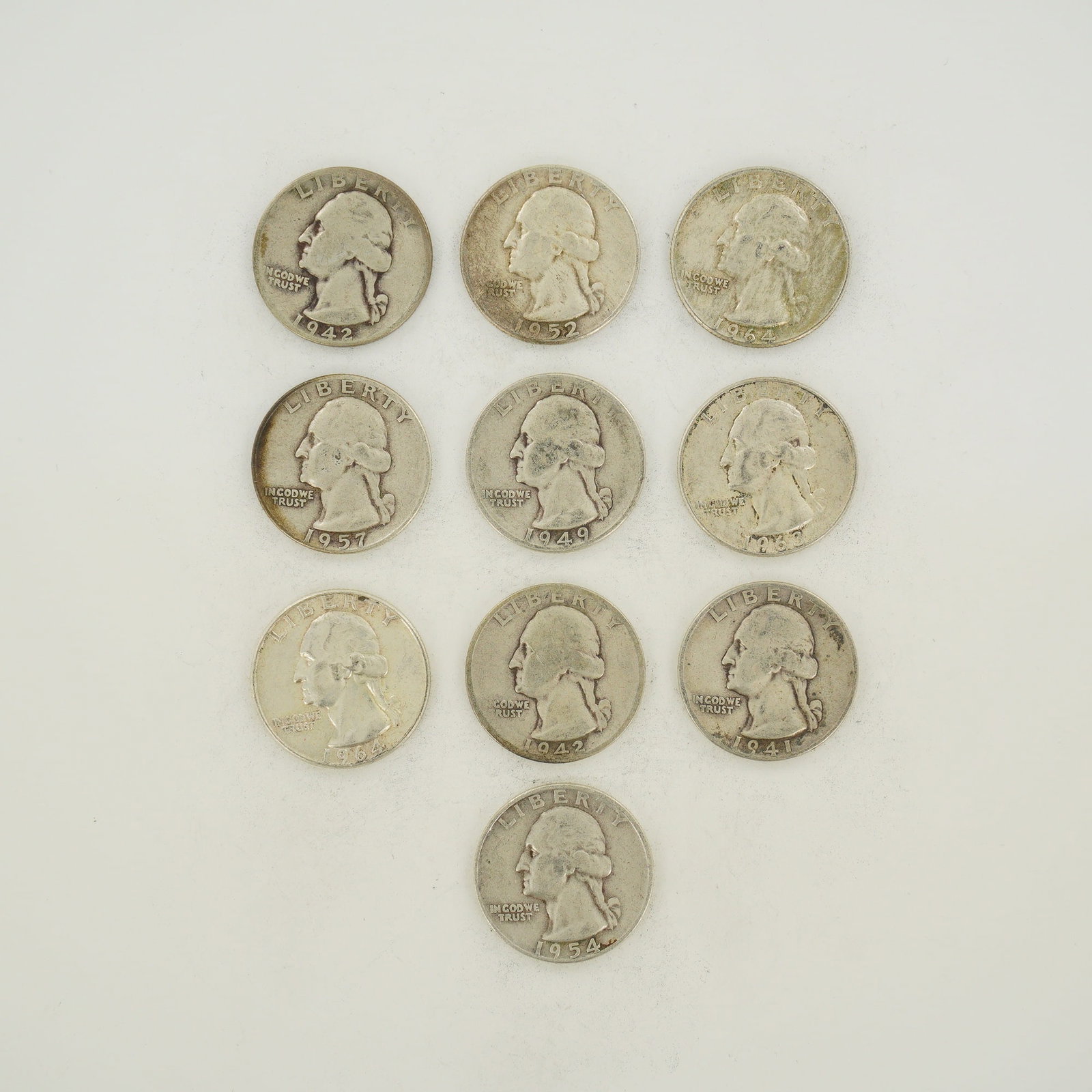 Ten US Silver Washington Quarters, 1941-1964: A collection of ten US Washington quarters composed of 90% silver and 10% copper. This mixed date bag of coins includes the following years: 1941, 1942, 1949, 1952, 1954, 1957, 1963, and 1964. The