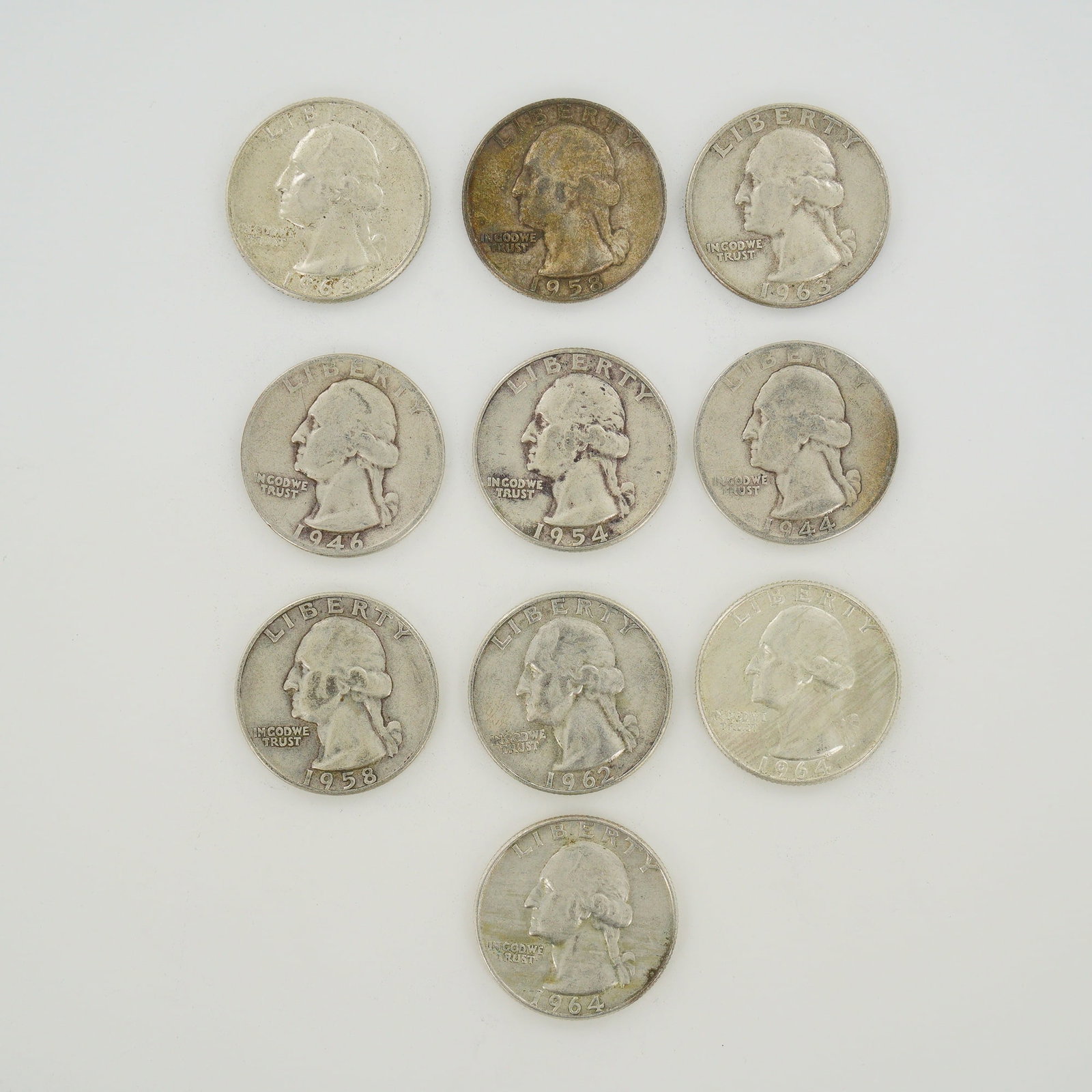 Ten US Washington Silver Quarter Dollars, 1944-1964: This mixed date bag of ten US Washington quarter dollars is struck in 90% silver. The collection includes coins with the following dates: 1944, 1946, 1954, 1958 (two), 1962, 1963 (two), and 1964 (two)