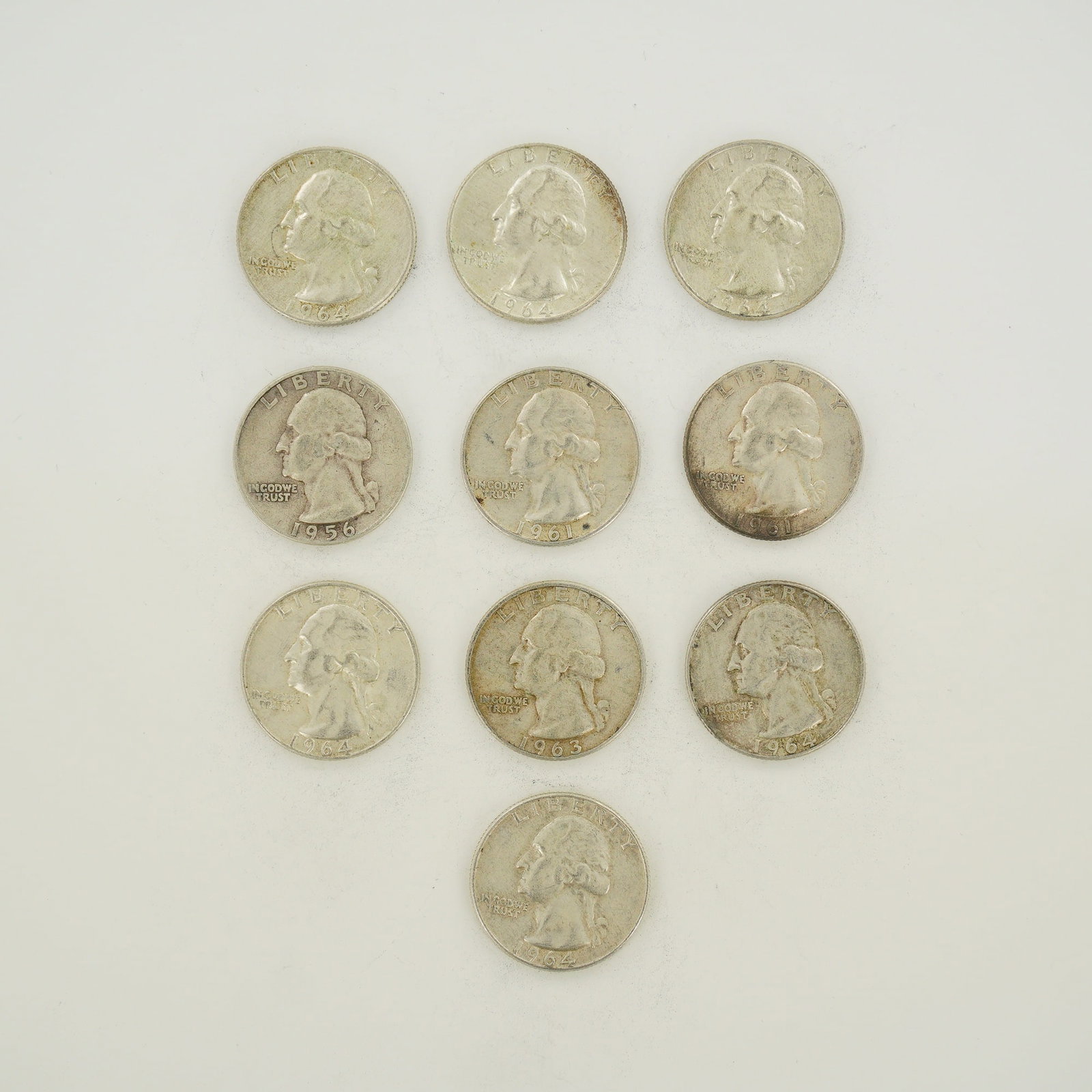 10pc Pre-1964 U.S. 90% Silver Washington Quarters: A collection of ten US 90 percent silver Washington Quarter Dollars, identified as a mixed date bag of silver coinage. The lot includes one 1956, two 1961, one 1963, and six 1964 dated coins. Each spe