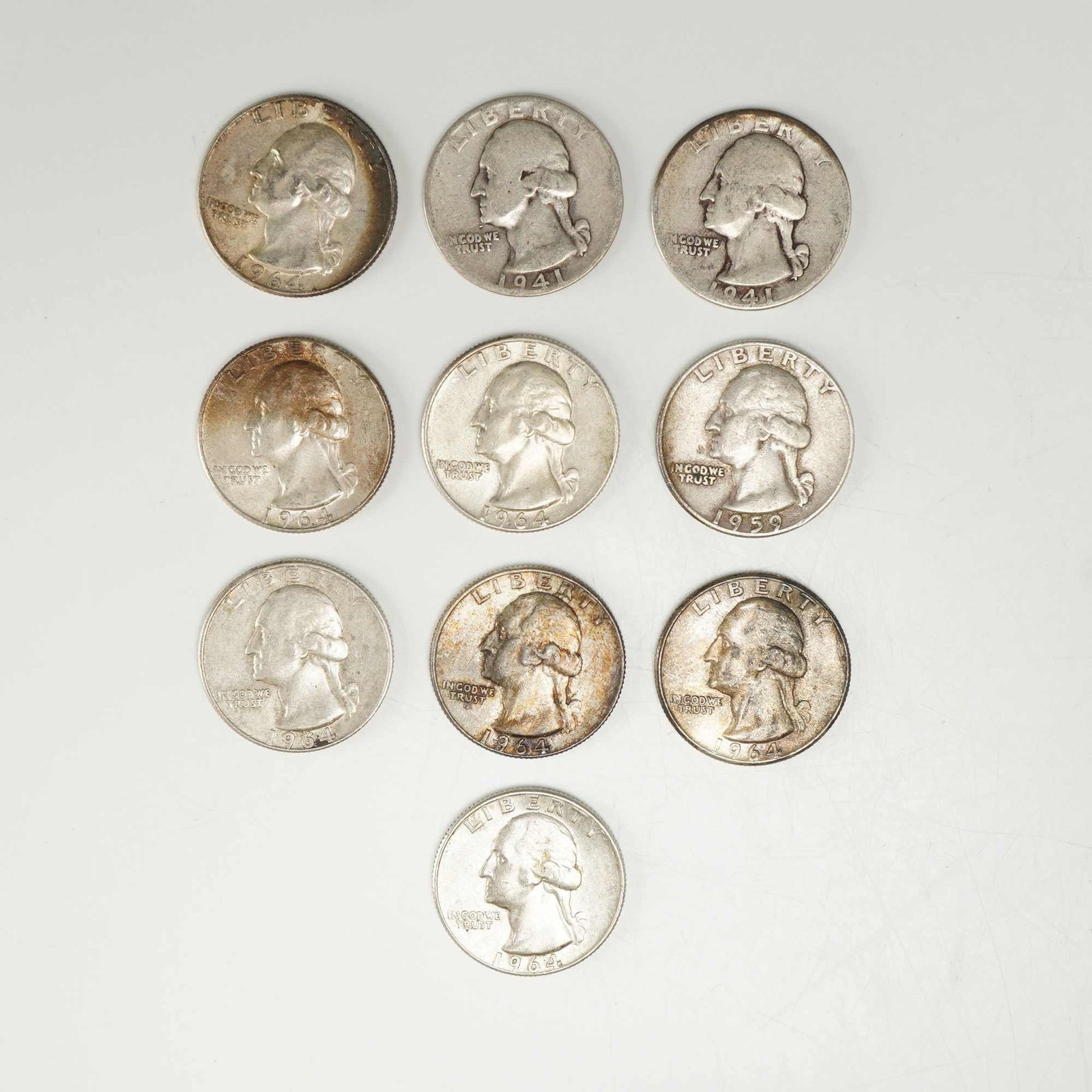 10pc Pre-1964 U.S. 90% Silver Washington Quarters: This collection represents a mixed date bag of US Washington silver quarters struck in 90% silver. The group features specimens with dates including 1941, 1959, and 1964. The assembly includes coins f