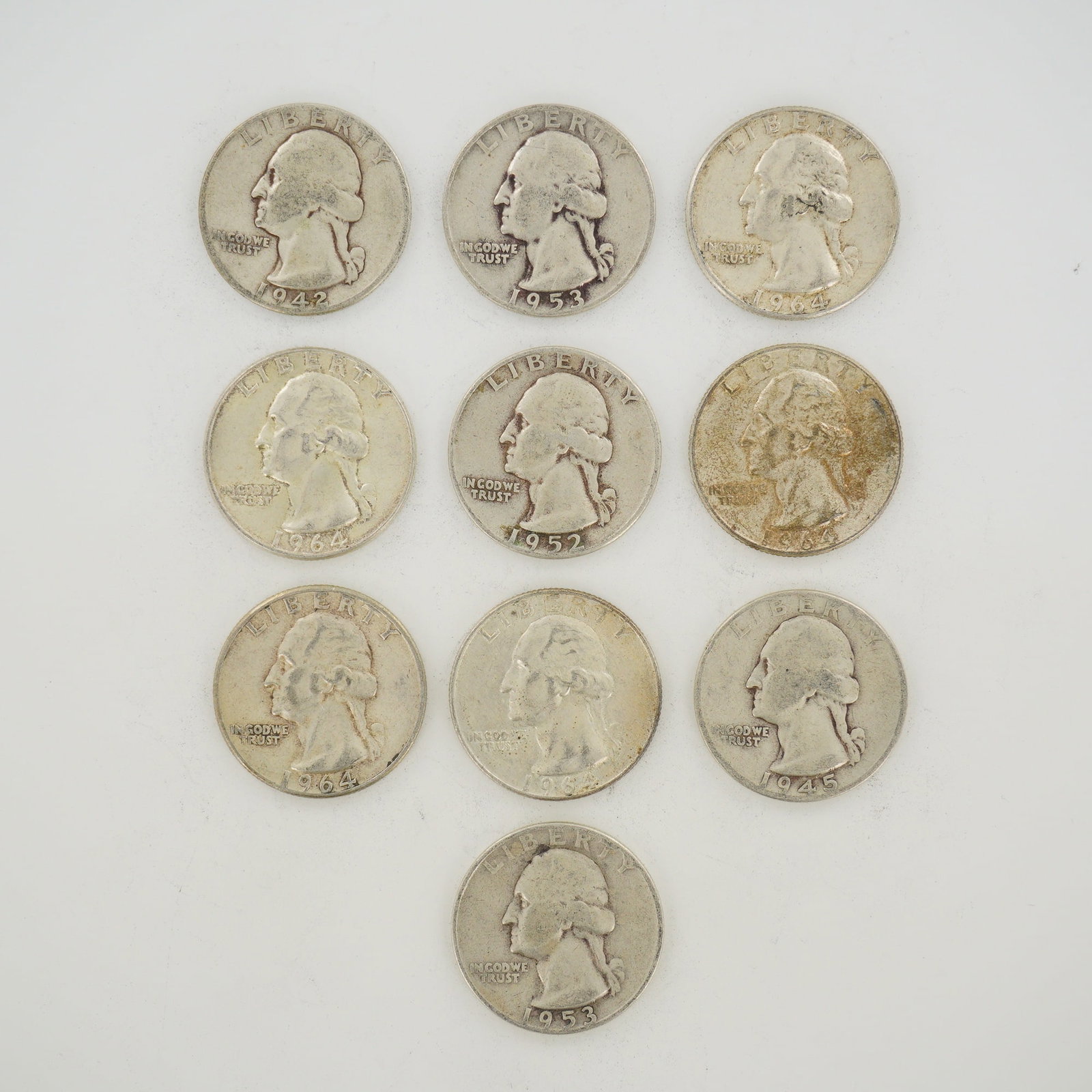 10pc Pre-1964 U.S. 90% Silver Washington Quarters: A group of US Washington quarters (KM# 164) struck in 90% silver. This mixed date bag of coinage includes various dates and mint marks such as 1942-D, 1945, 1952, 1953-D, 1964, and 1964-D. Each coin f