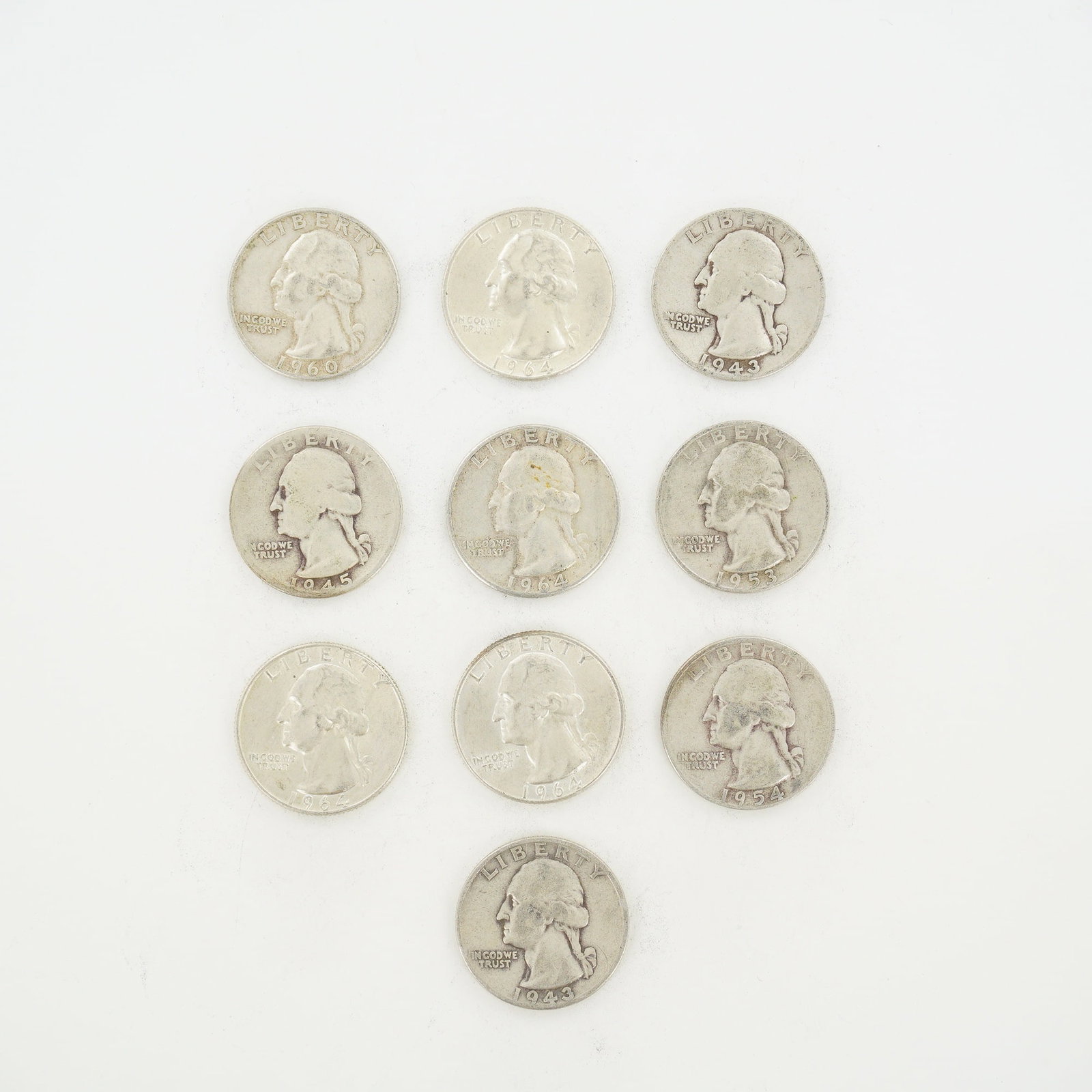 10pc Pre-1964 U.S. 90% Silver Washington Quarters: A collection of ten US Washington Quarter Dollars struck in 90% silver. The group includes two coins dated 1943, one dated 1945, one dated 1953, one dated 1954, one dated 1960, and four dated 1964. Ea