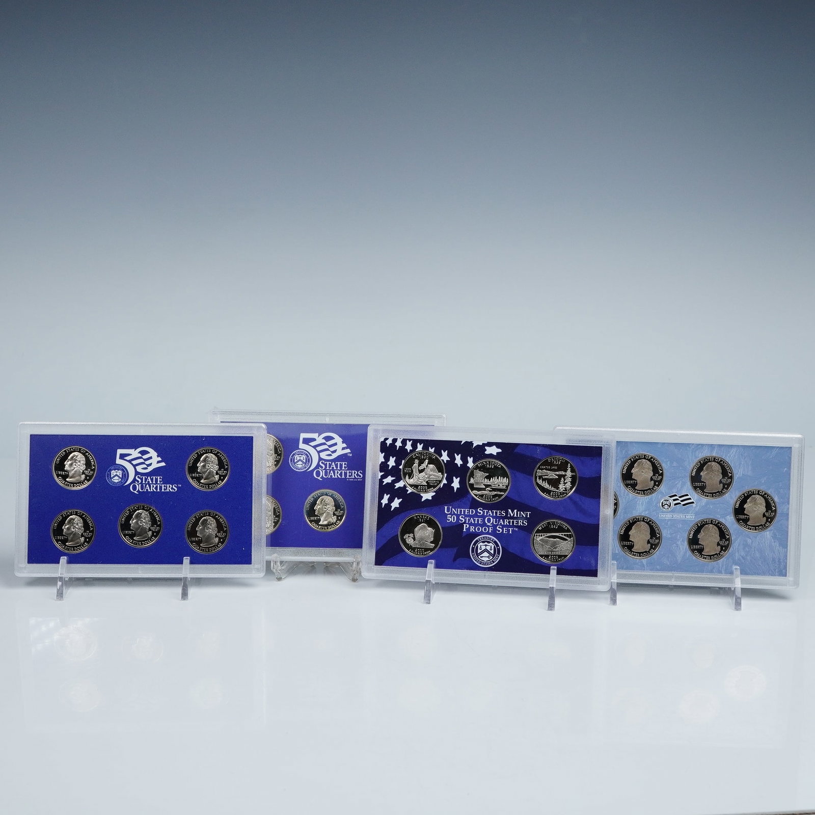 4pc 1999-2009 United States Mint 50 State Quarters Proof Sets: Four United States Mint 50 State Quarters Proof Sets, each housed in its original presentation case with matching outer box and certificate of authenticity. Each set contains five or six proof coins r