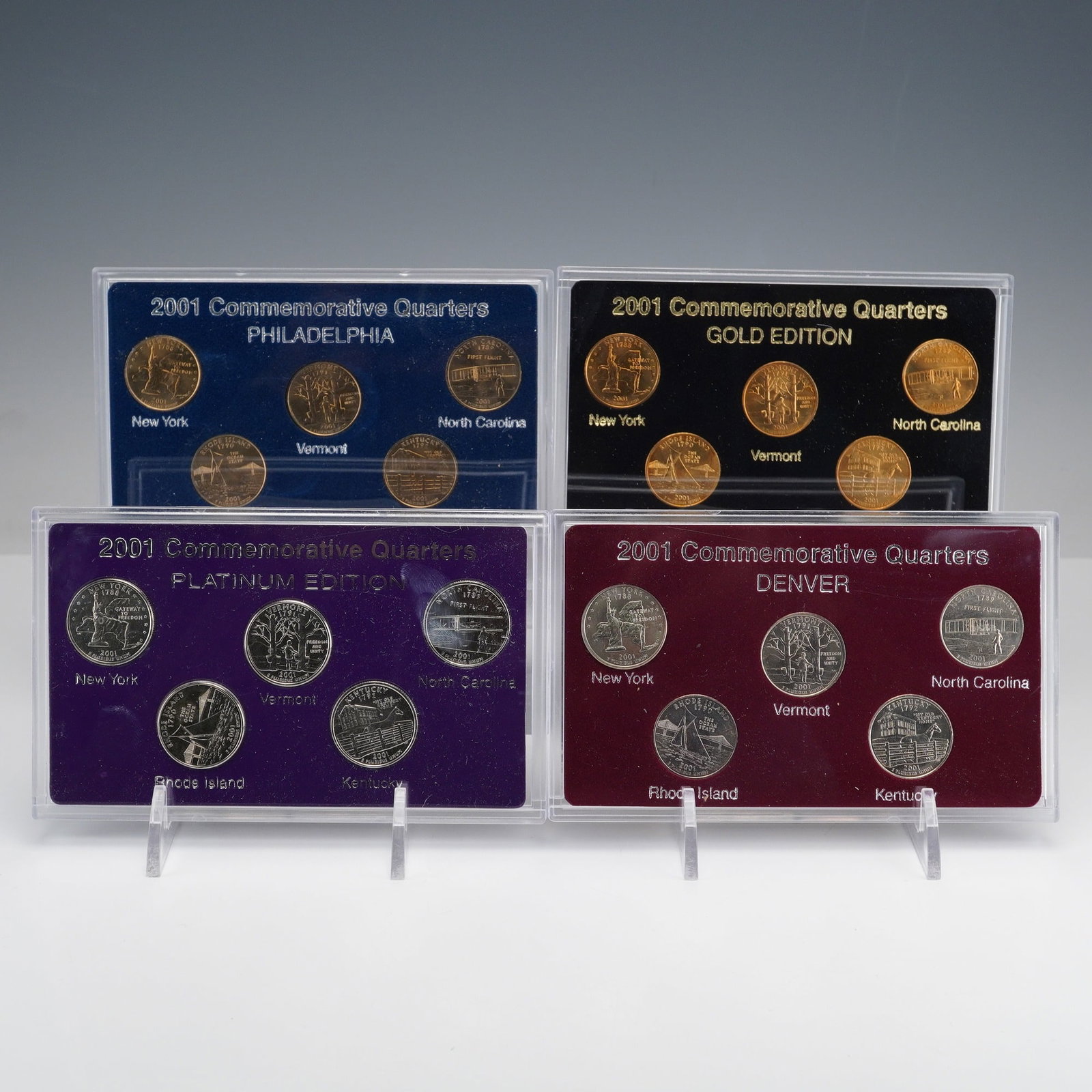 4pc 2001 United States Commemorative Quarter Sets: Four 2001 Commemorative Quarter sets featuring enhanced or standard-finish United States 50 State Quarters, each housed in a clear acrylic display case with matching decorative box. The collection inc