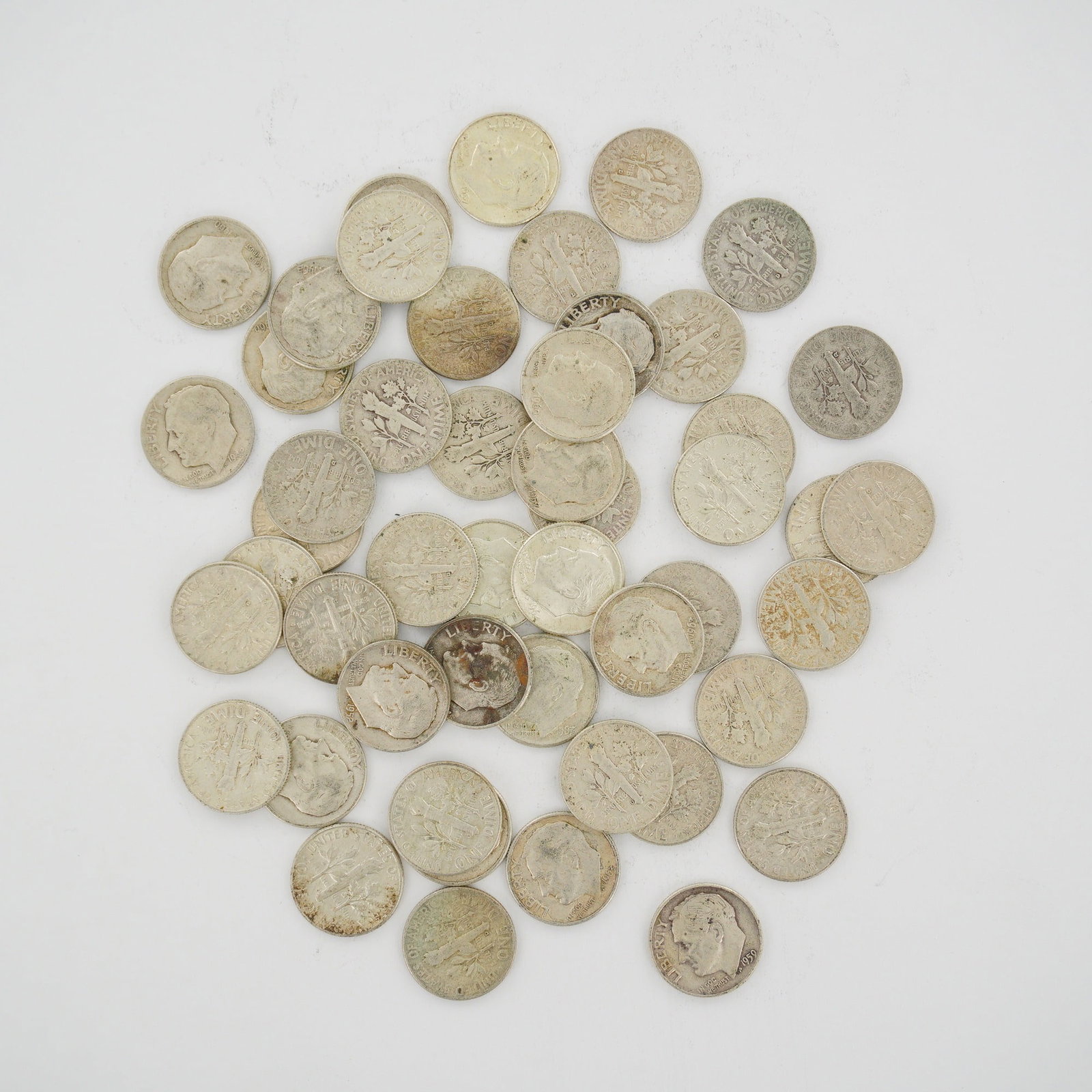 A Mixed Date Bag of US 90% Silver Roosevelt Dimes: This collection consists of multiple US Roosevelt Dimes struck in 90% silver and 10% copper. The lot is a mixed date bag of coins featuring dates such as 1950, 1952, 1957, 1960, 1963, and 1964. Mint m
