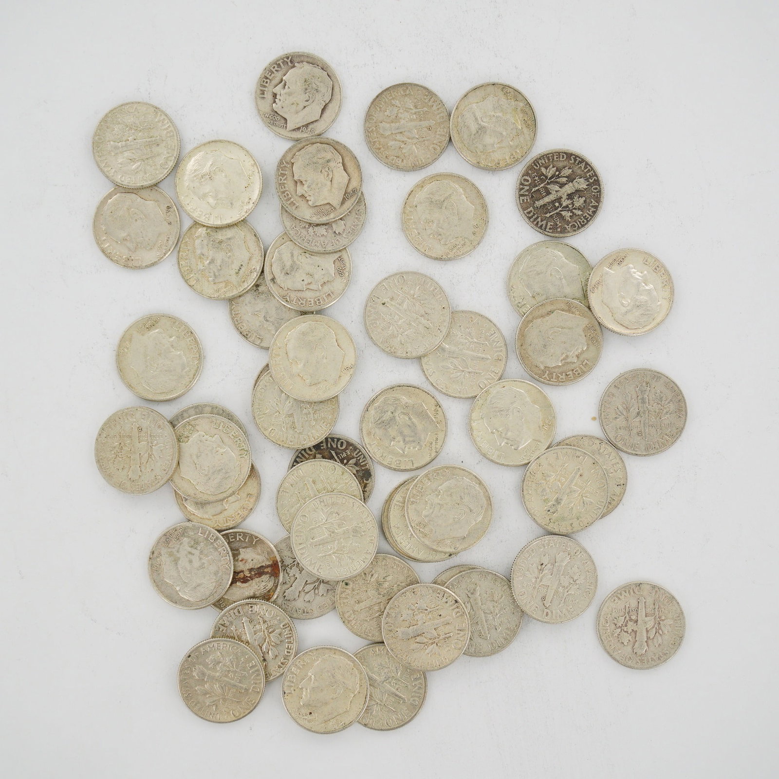 A Collection of United States 90% Silver Roosevelt Dimes in a Mixed Date Bag: A collection of United States Roosevelt dimes struck in 90% silver. This mixed date bag of coins includes various issues minted prior to 1965. The obverse of each coin features the profile of Presiden