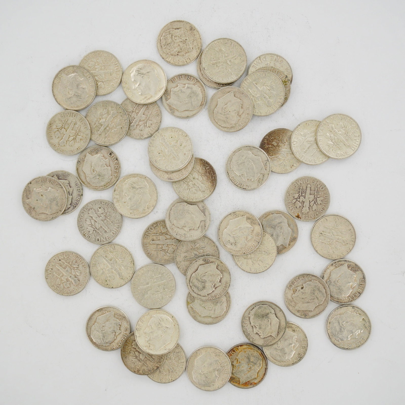 A Collection of US 90% Silver Roosevelt Dimes, Mixed Dates: This collection of US Roosevelt dimes is presented as a mixed date bag of 90% silver coins minted prior to 1965. The assortment includes various years such as 1947, 1953, 1954, 1956, 1959, 1962, and