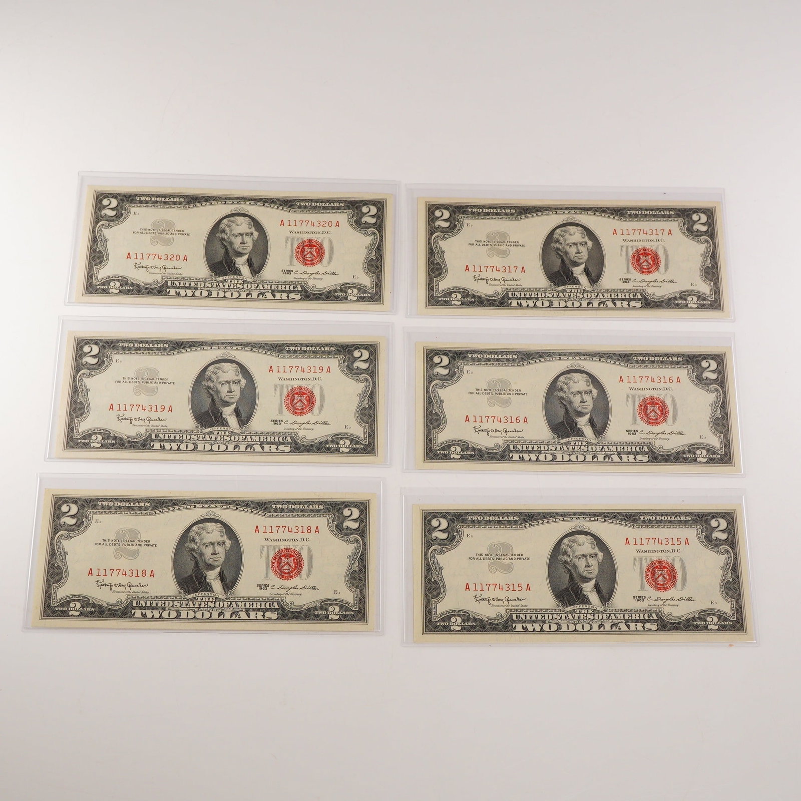 6pc 1963 U.S. Two Dollar Red Seal Consecutive Notes: Six 1963 U.S. $2 Red Seal Legal Tender Notes, each bearing consecutive serial numbers A11774315A through A11774320A. The obverse features the portrait of Thomas Jefferson at center with red Treasury s