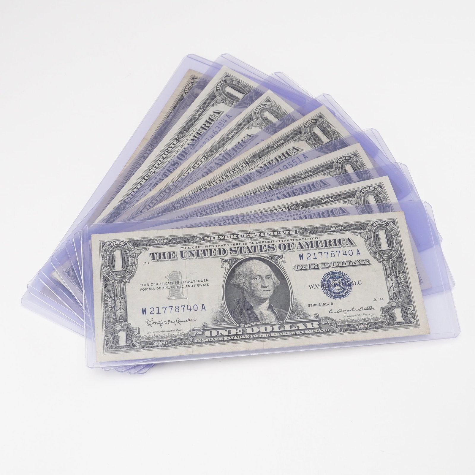 7pc 1957, 1957 A&B U.S. Silver Certificate One Dollar Notes: Silver Certificate one dollar notes comprising of three Series 1957, three Series 1957A, and one Series 1957B. Each note displays the portrait of George Washington on the obverse with the distinctive 