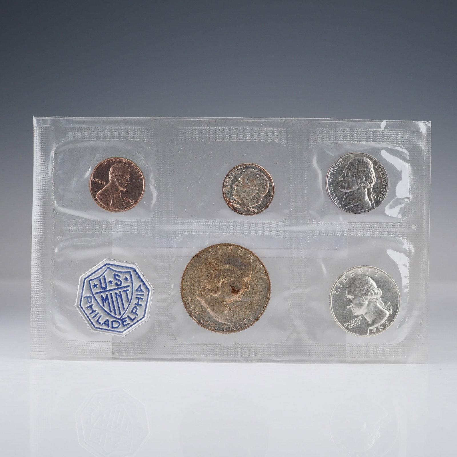 1963 U.S. Mint Philadelphia 5 Coin Proof Set: This official U.S. Mint set from Philadelphia includes five proof coins from 1963: the Franklin half dollar, Washington quarter, Roosevelt dime, Jefferson nickel, and Lincoln cent. Each coin displays 