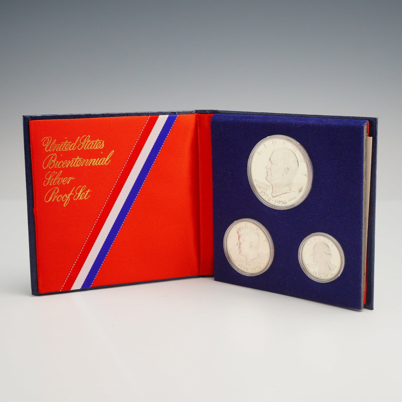 Three-Coin USA Bicentennial Silver Proof Set 1776-1976: Three-coin USA Bicentennial Silver Proof Set containing an Eisenhower Dollar, a Kennedy Half Dollar, and a Washington Quarter. Each coin is dual-dated 1776-1976 and bears the S mint mark for the San