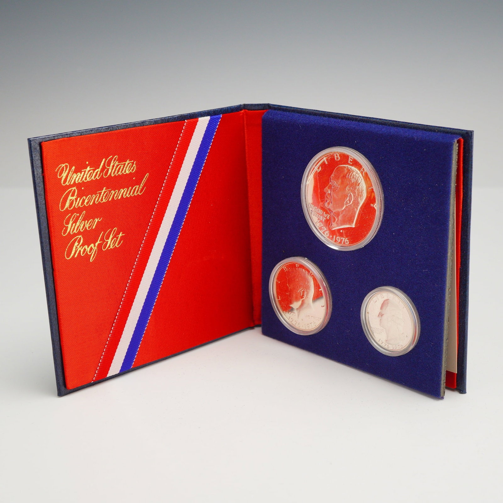 US 1776-1976 Bicentennial Silver Proof Set: This three-coin US bicentennial silver proof set consists of a Washington quarter, a Kennedy half dollar, and an Eisenhower dollar. Each coin is struck in a 40 percent silver composition and bears the