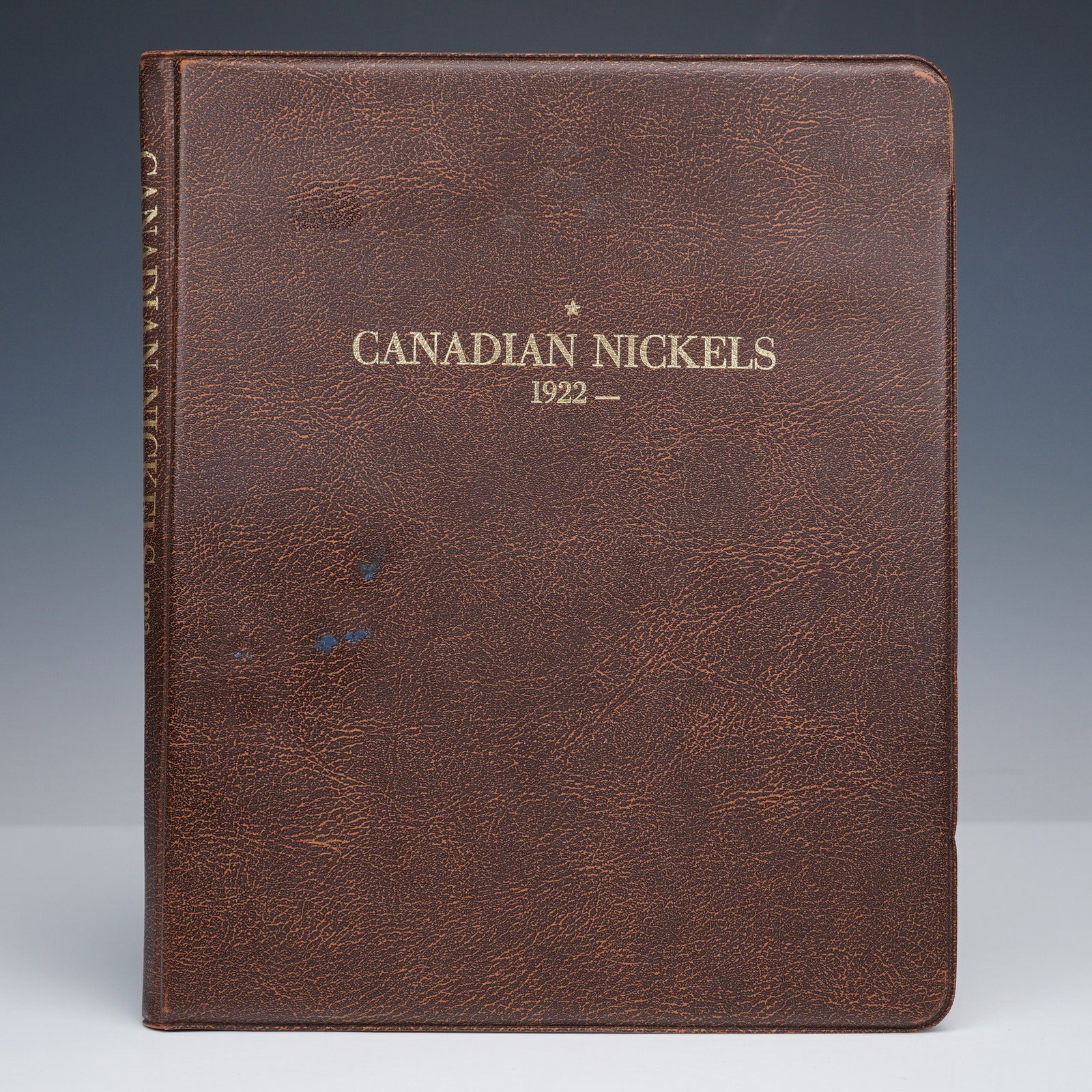 1922 to 2004 Binder Bound Canadian 5 Cent Collection: Housed in a brown album titled "Canadian Nickels 1922," this set includes an array of 83 Canadian 5-cent pieces featuring notable designs such as the beaver motif and portraits of monarchs including E