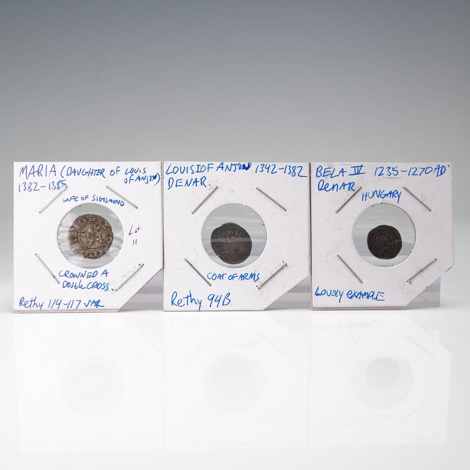 3pc 1235 to 1385 Medieval Hungarian Maria, Louis, & Bela Denar Coins: A group of three medieval Hungarian silver denars spanning the 13th to 14th centuries. The first coin, issued under Maria (1382-1385), daughter of Louis of Anjou and wife of Sigismund, features a crow