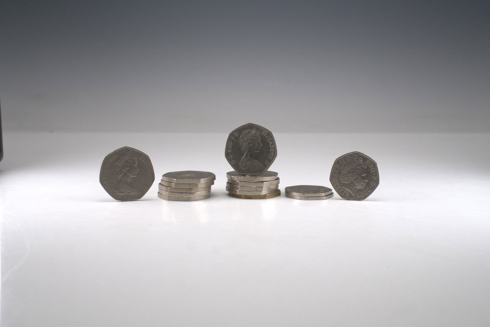 15pc United Kingdom 50 Pence Coin Set: Each coin bears the portrait of Queen Elizabeth II on the obverse, with Britannia and other symbolic motifs represented on the reverses. Includes the notable 1973 European Economic Community commemora