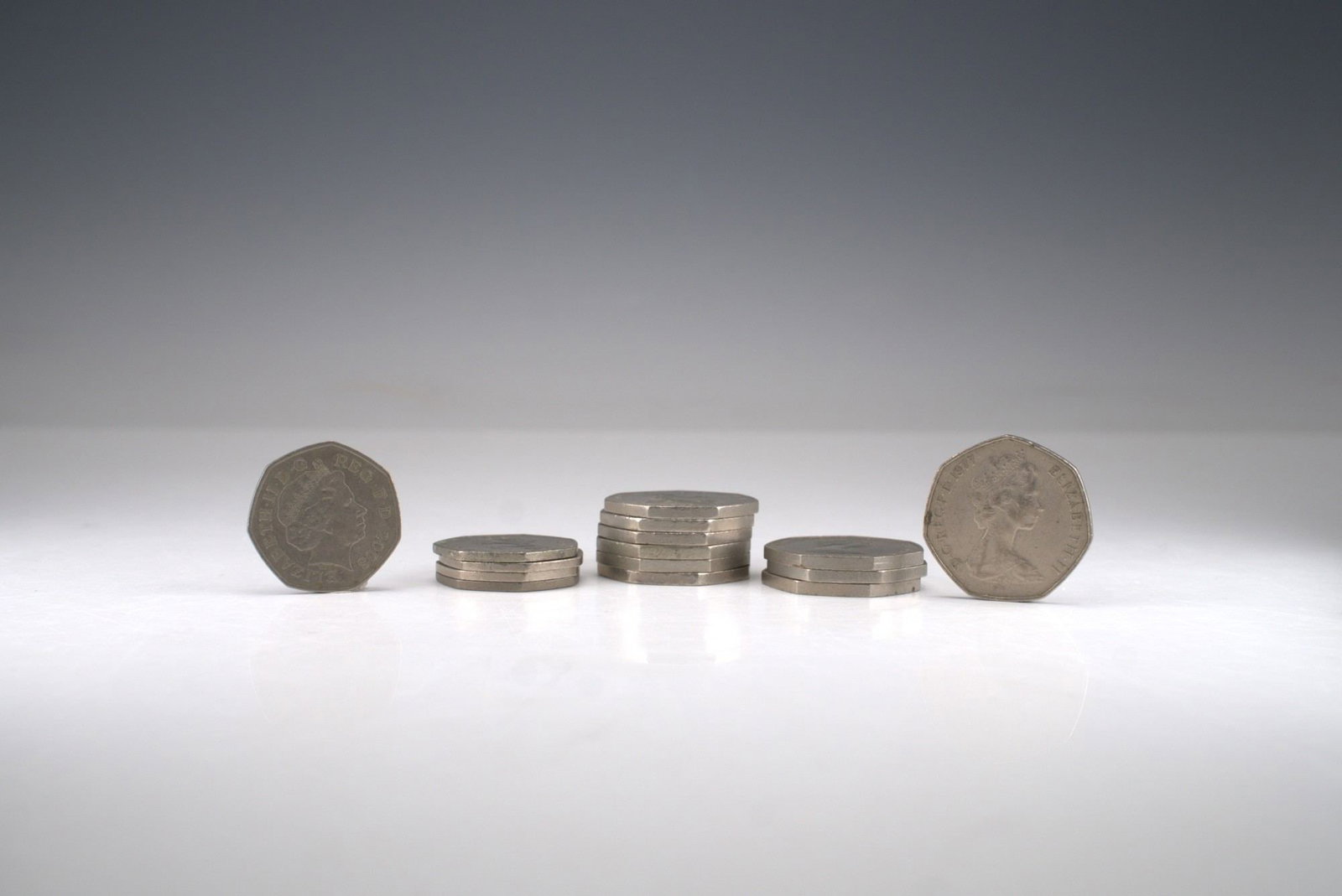 15pc United Kingdom 50 Pence Coin Set: A collection of various years , each bearing the portrait of Queen Elizabeth II on the obverse and the seated Britannia design on the reverse. Struck in cupro-nickel and characterized by the distincti