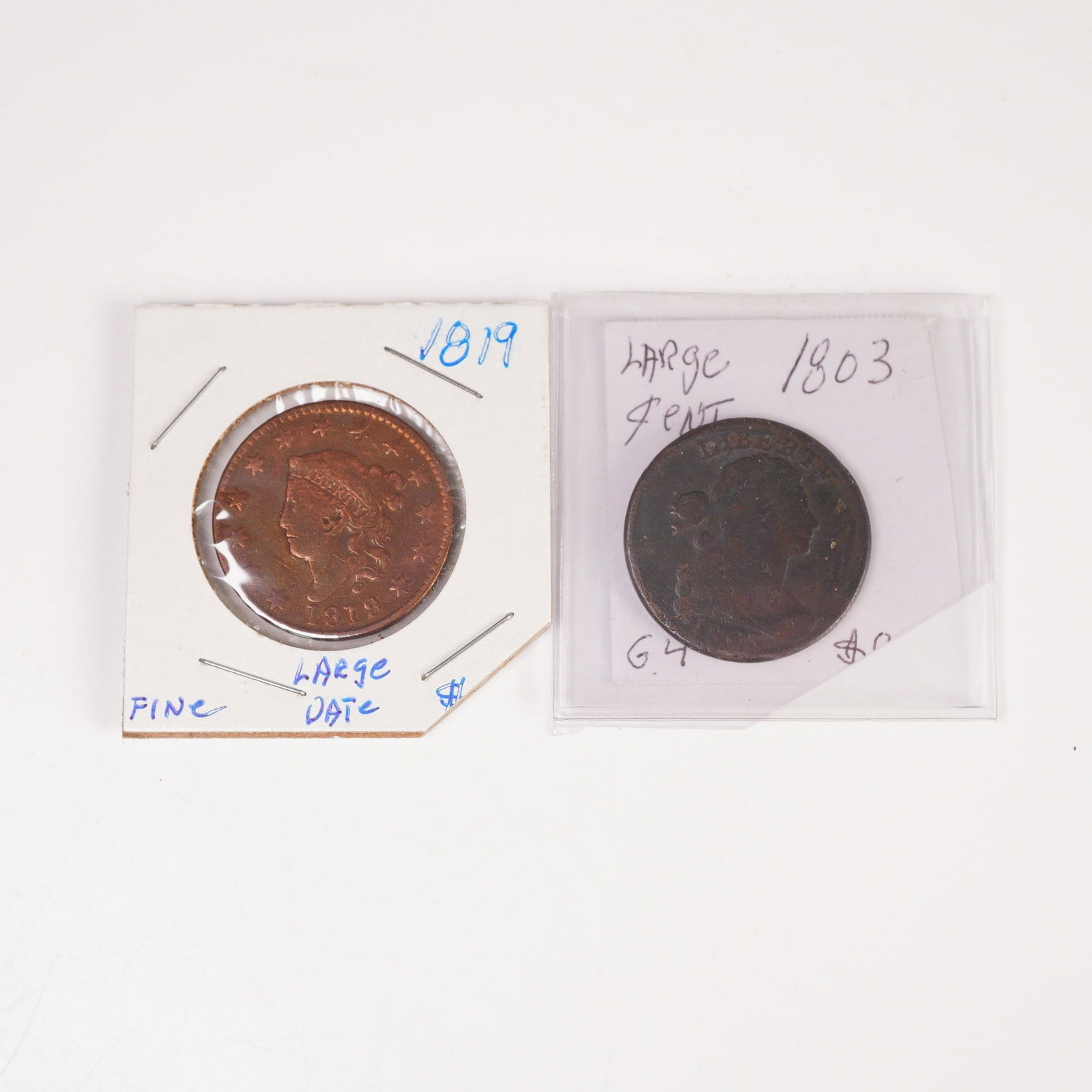 2pc 1803 Draped Bust & 1819 Matron Head (Type 1) 1 Cent Coins: A 1803 Draped Bust Cent featuring a right-facing Liberty on the obverse with LIBERTY and the date, and a reverse displaying a wreath surrounding ONE CENT with UNITED STATES OF AMERICA. Also included