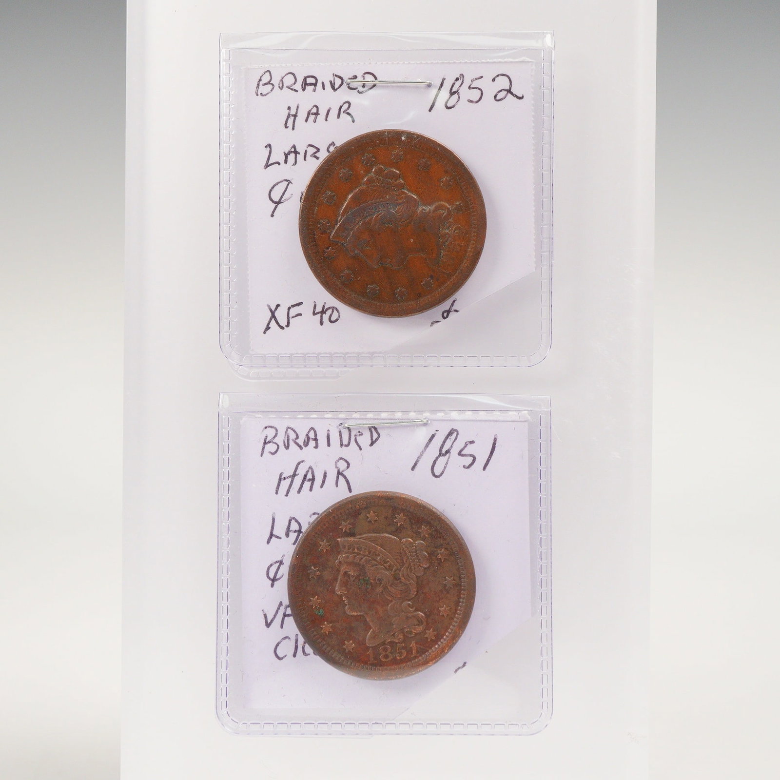 2pc 1851, 1852 U.S. Braided Hair Large One Cent Coins: A two-piece lot of United States Braided Hair Large Cents dated 1851 and 1852, each struck in copper and bearing the final large cent design type used prior to the switch to small cent coinage in