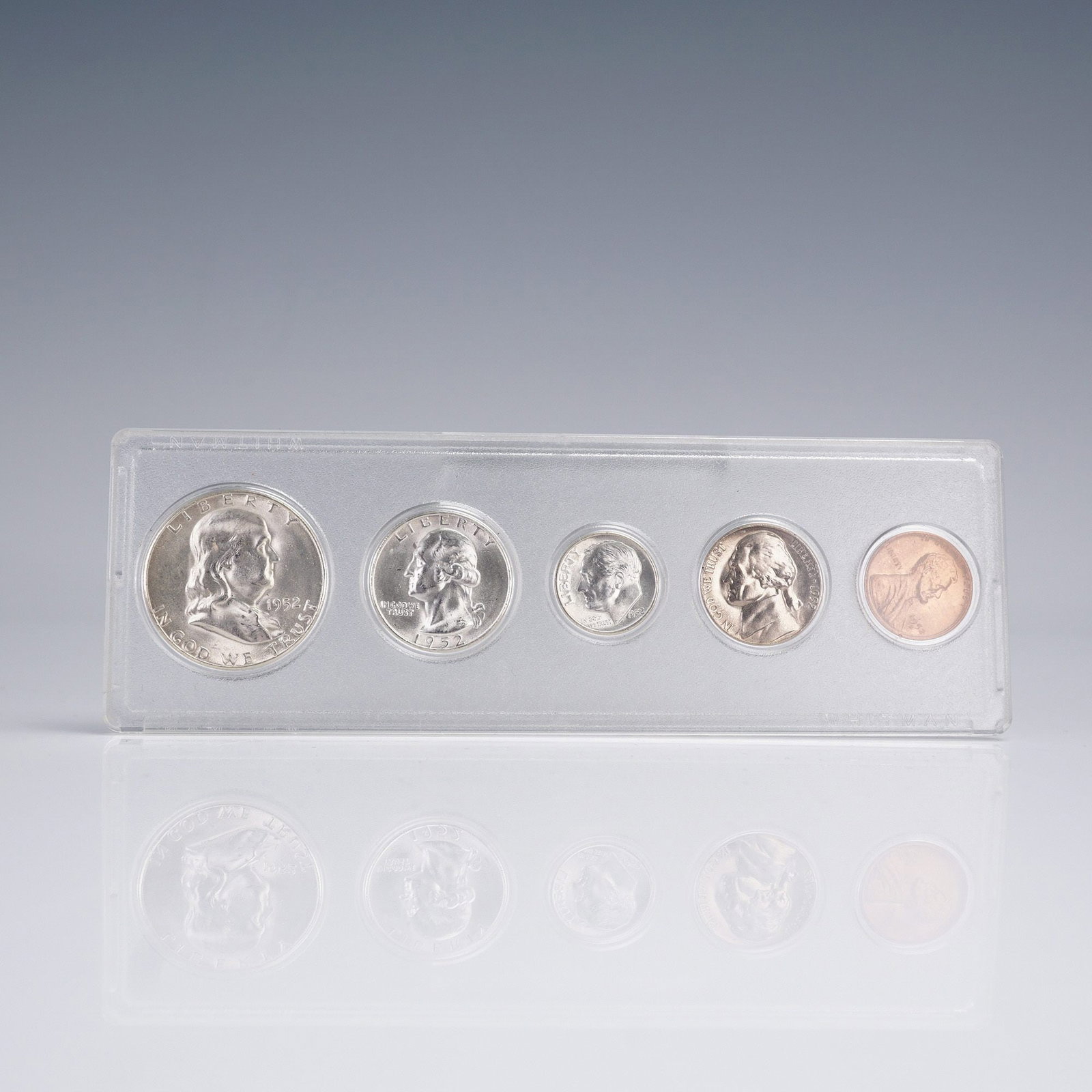 1952 United States 5 Coin Set: A vintage 1952 United States 5-coin set presented in a clear protective display case. The set includes one example each of the Franklin Half Dollar, Washington Quarter, Roosevelt Dime, Jefferson