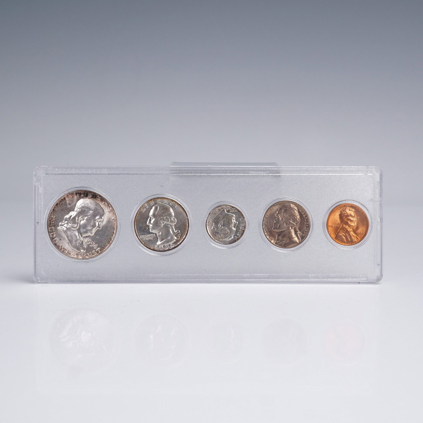 1956 United States 5 Coin Set: A 1956 United States 5-coin set housed in a clear protective holder. This mid-century set includes one each of the Franklin Half Dollar, Washington Quarter, Roosevelt Dime, Jefferson Nickel, and Linco