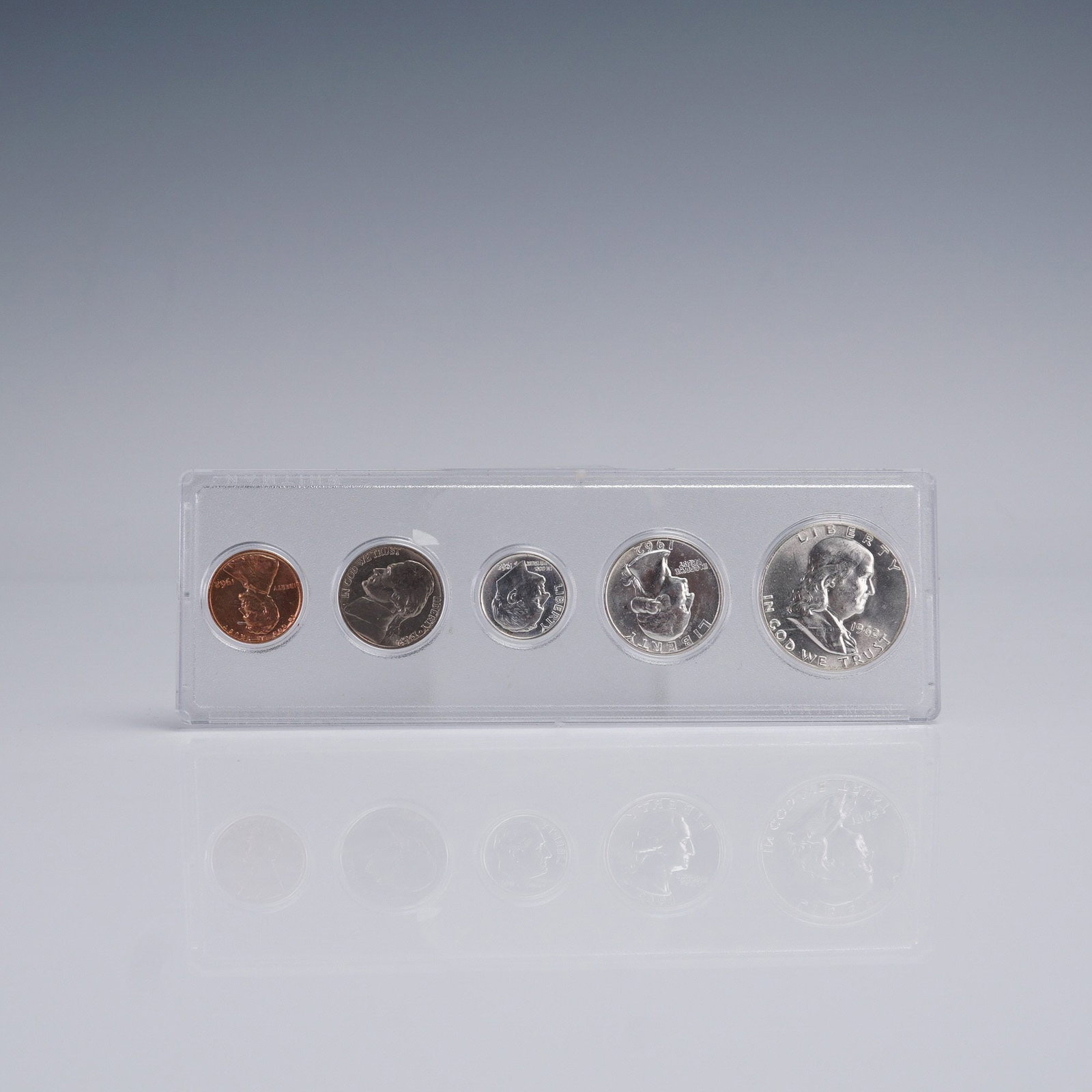 1962 United States 5 Coin Set: A 1962 United States 5-coin set presented in a clear protective display case. The set includes a Franklin Half Dollar, Washington Quarter, Roosevelt Dime, Jefferson Nickel, and Lincoln Cent - all date