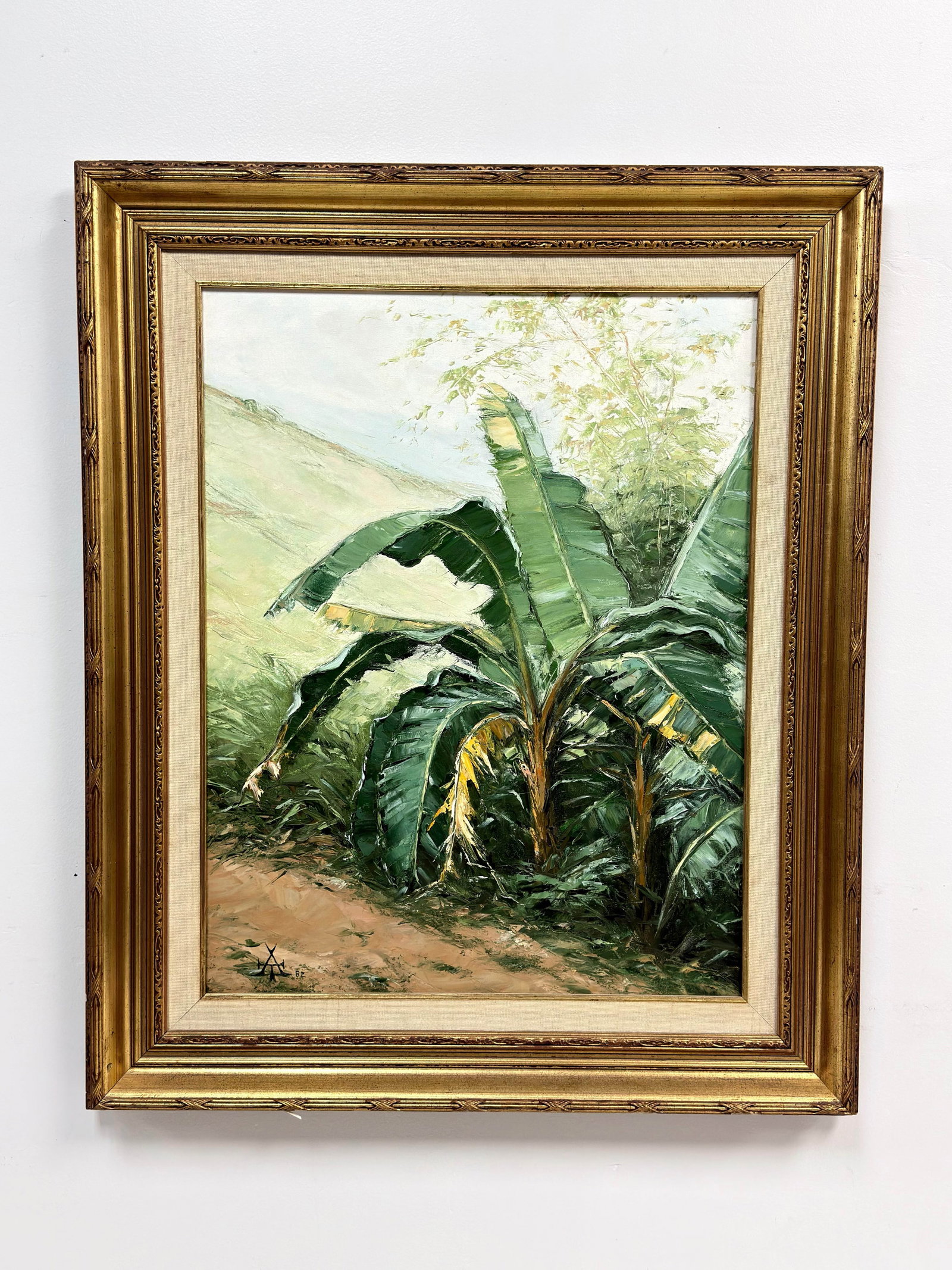 Los Cambures, Oil on Canvas, 1982: An oil painting on stretched canvas , titled Los Cambures and dated 1982. The composition focuses on a cluster of banana trees within a tropical landscape, featuring a dusty path in the foreground and