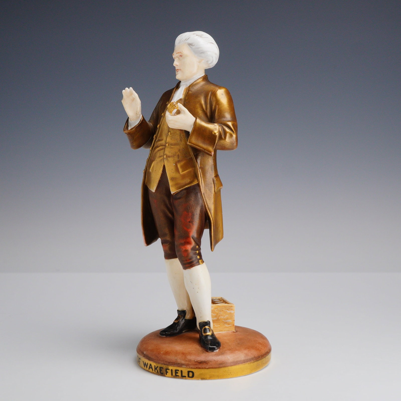Vicar of Wakefield Porcelain Figurine: A porcelain character figurine titled Vicar of Wakefield, attributed to the Rubin Collection and potentially associated with Wedgwood production. The figure represents Dr. Charles Primrose, the centra