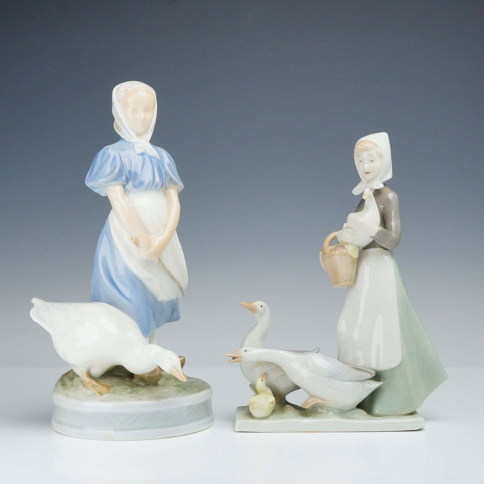 Two Royal Copenhagen Porcelain Figurines Girl with Goose and Carl Scheidig Peasant Girl with Geese: This lot features two glazed porcelain figurines depicting pastoral scenes, both executed with hand-painted underglaze decoration. The first figurine is a Royal Copenhagen production titled Goose Girl