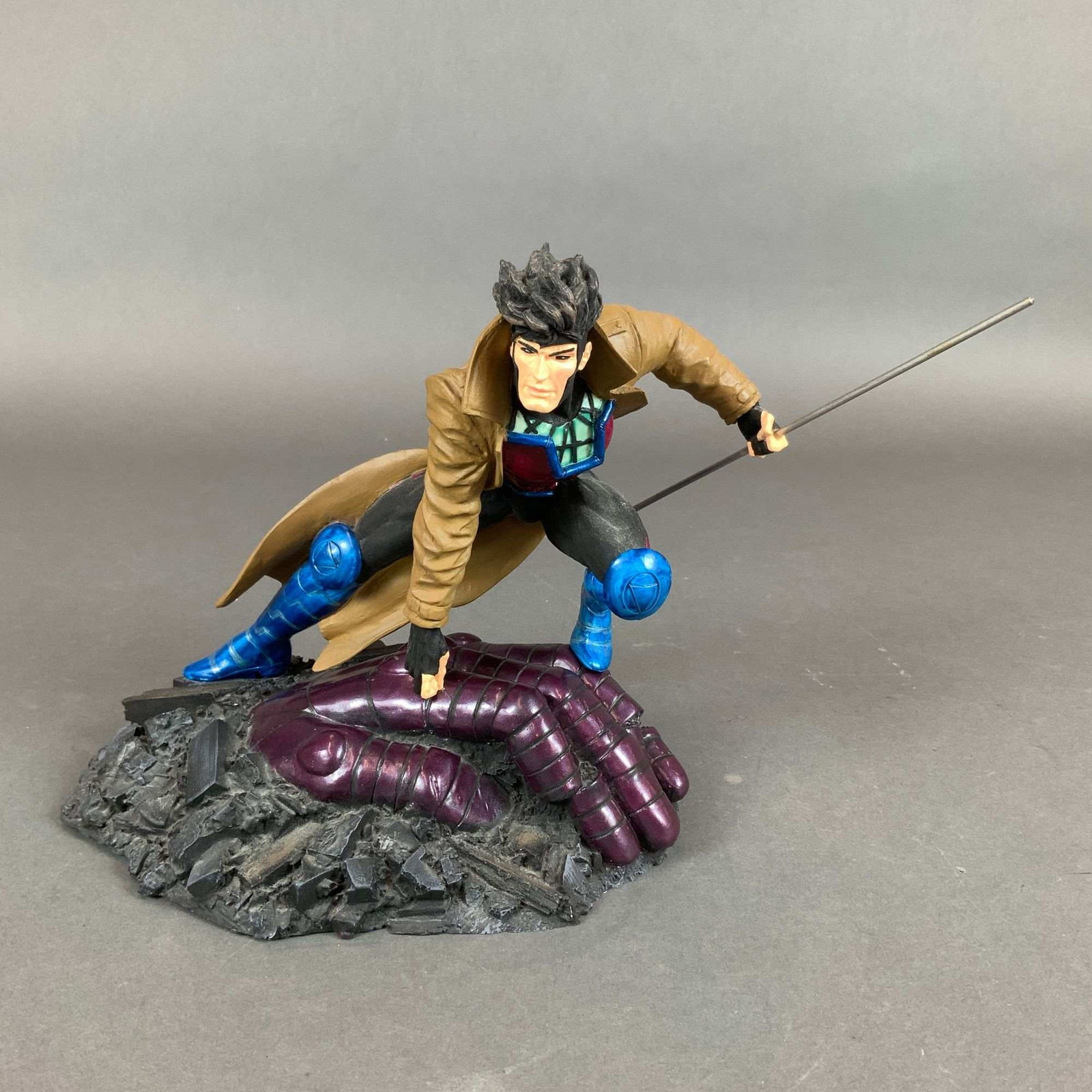X-Men Gambit Limited Edition Figurine with Base: This hand-painted figurine with base is a cold-cast porcelain statue of the X-Men character Gambit, also known as Remy LeBeau. Produced by Moore Creations, Inc., it was sculpted by Clayburn Moore.