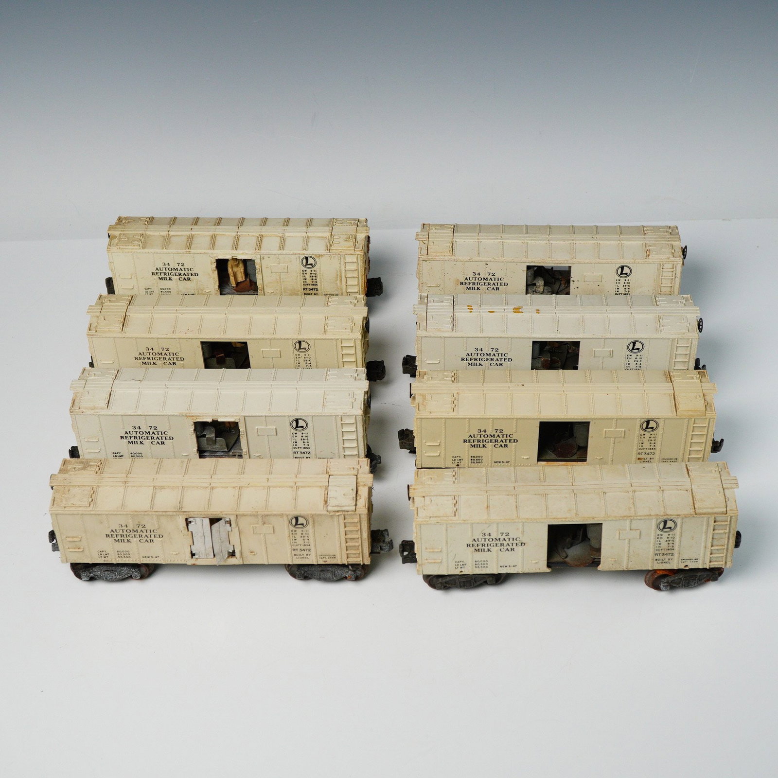 8 Lionel O Gauge 3472 Automatic Refrigerated Milk Train Cars: A collection of eight (8pc) vintage Lionel O Gauge model railroad cars, specifically the Post-War era No. 3472 Automatic Refrigerated Milk Car (RT3472). Each car features a cream-colored molded plasti