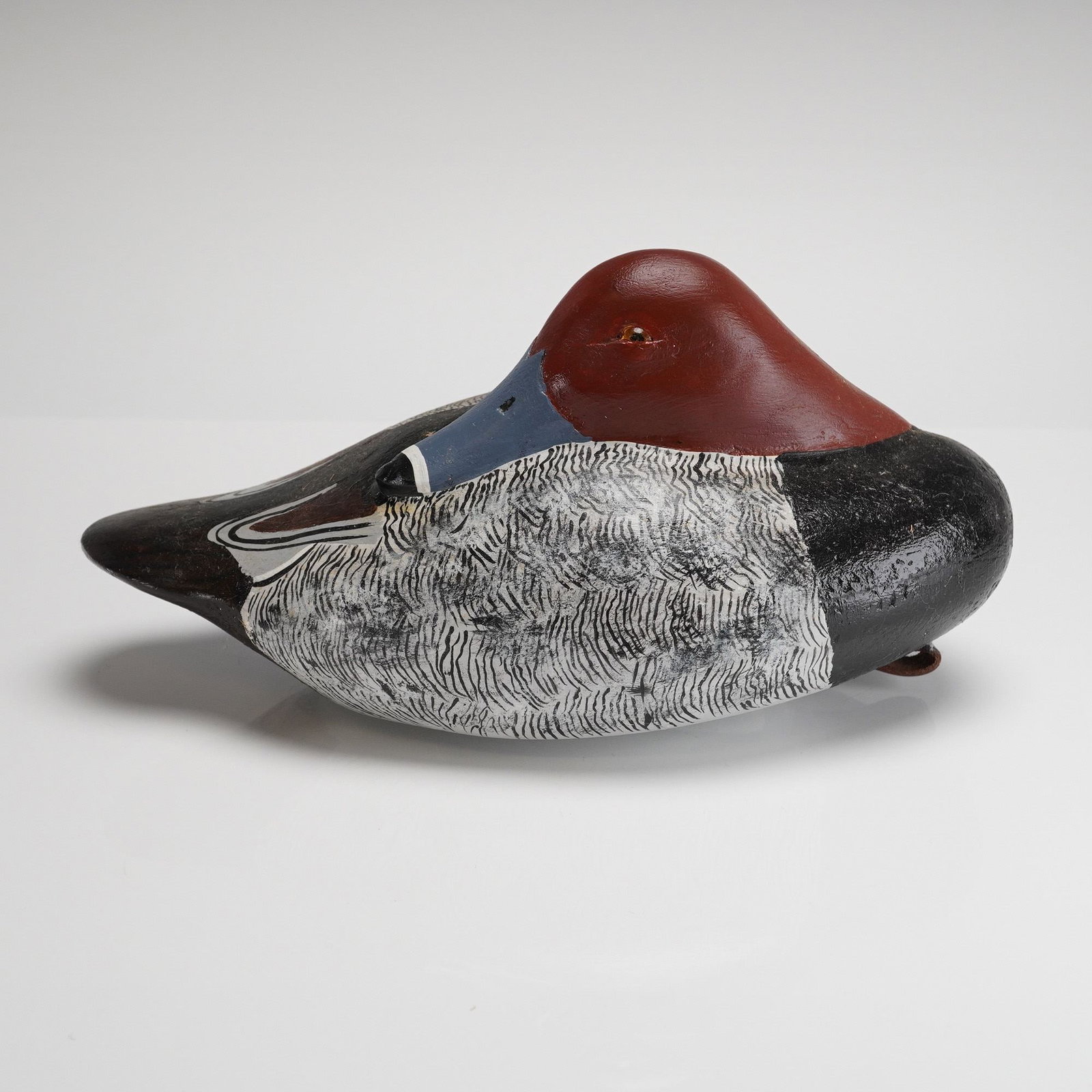Frank Flicker Hand-Carved Balsawood Redhead Drake Duck Decoy: This is a vintage, hand-carved folk art duck decoy attributed to the recognized carver Frank Flicker. The piece depicts a Redhead Drake, featuring a reddish-brown head, black body, and flanks painted