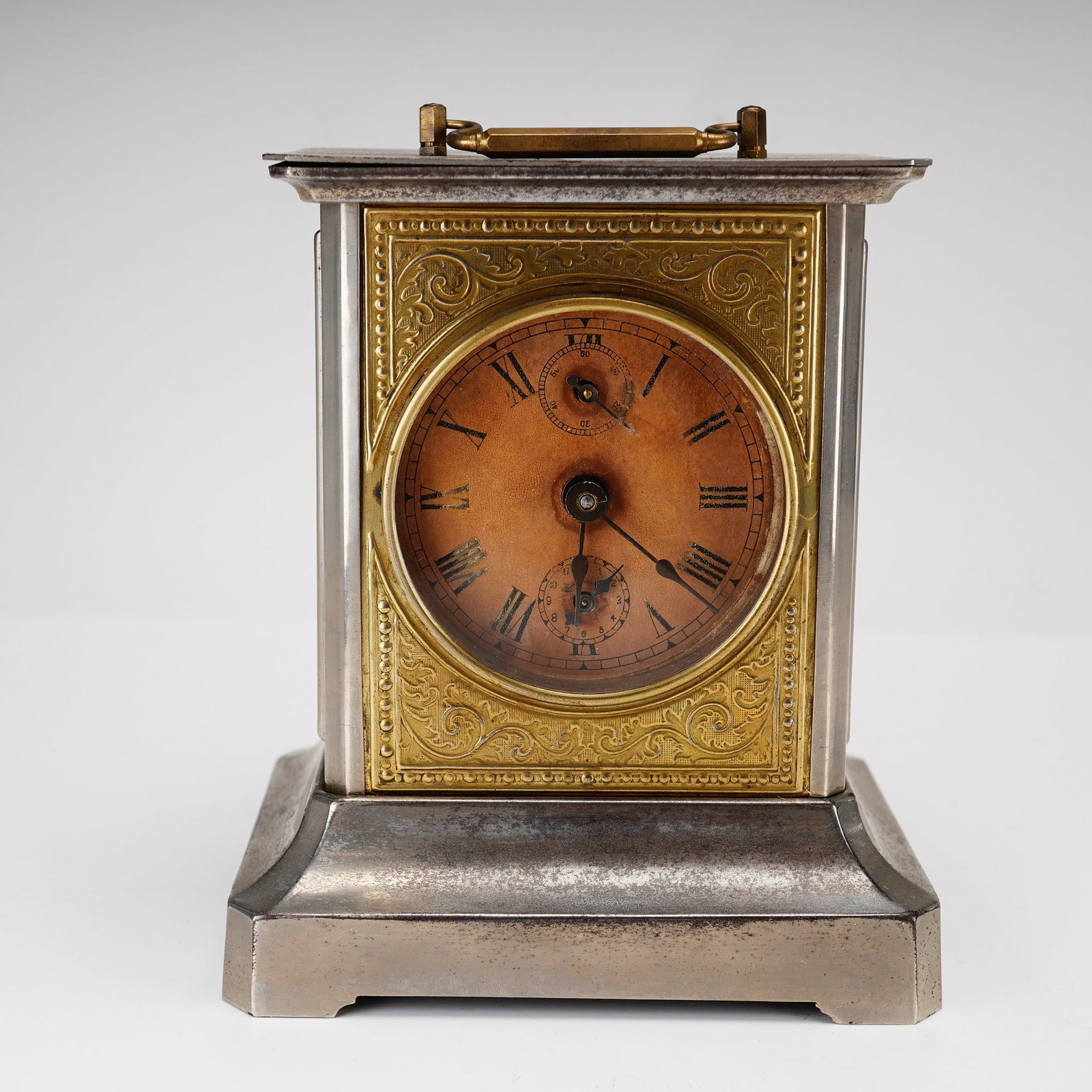German Nickel-Plated Carriage Alarm Clock Early 20th Century: This German carriage-style alarm clock dates to the first half of the 20th century. The rectangular architectural case is constructed from nickel-plated metal featuring a wide tiered base and a