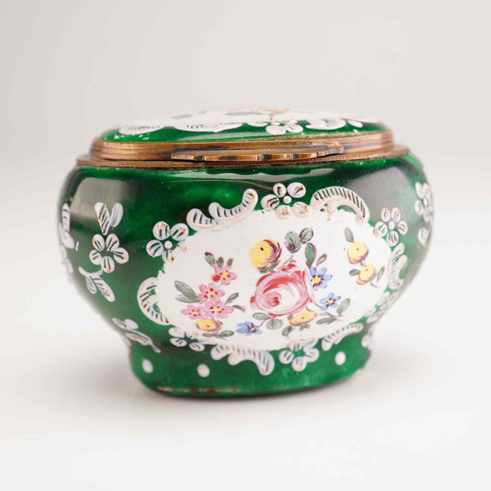 19th Century Hand Painted Enamel Treasure Box: This 19th century hinged treasure box is designed with an aesthetic reminiscent of hand painted porcelain. The item is constructed of enamel over a copper base with scalloped gilt-metal mounts. The