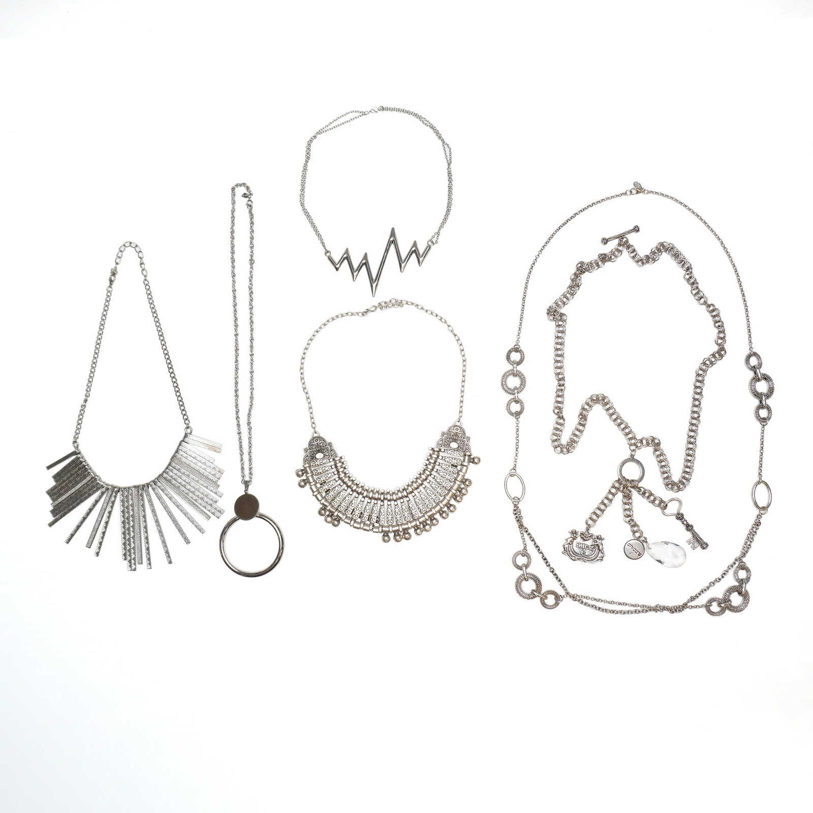 A 6pc Collection of Silver-Tone Statement and Fashion Necklaces Including Chico's and Sarah Coventry: This six-piece lot of silver-tone costume jewelry features an assortment of contemporary and vintage-style necklaces. The collection includes a fringe statement collar necklace crafted with textured r