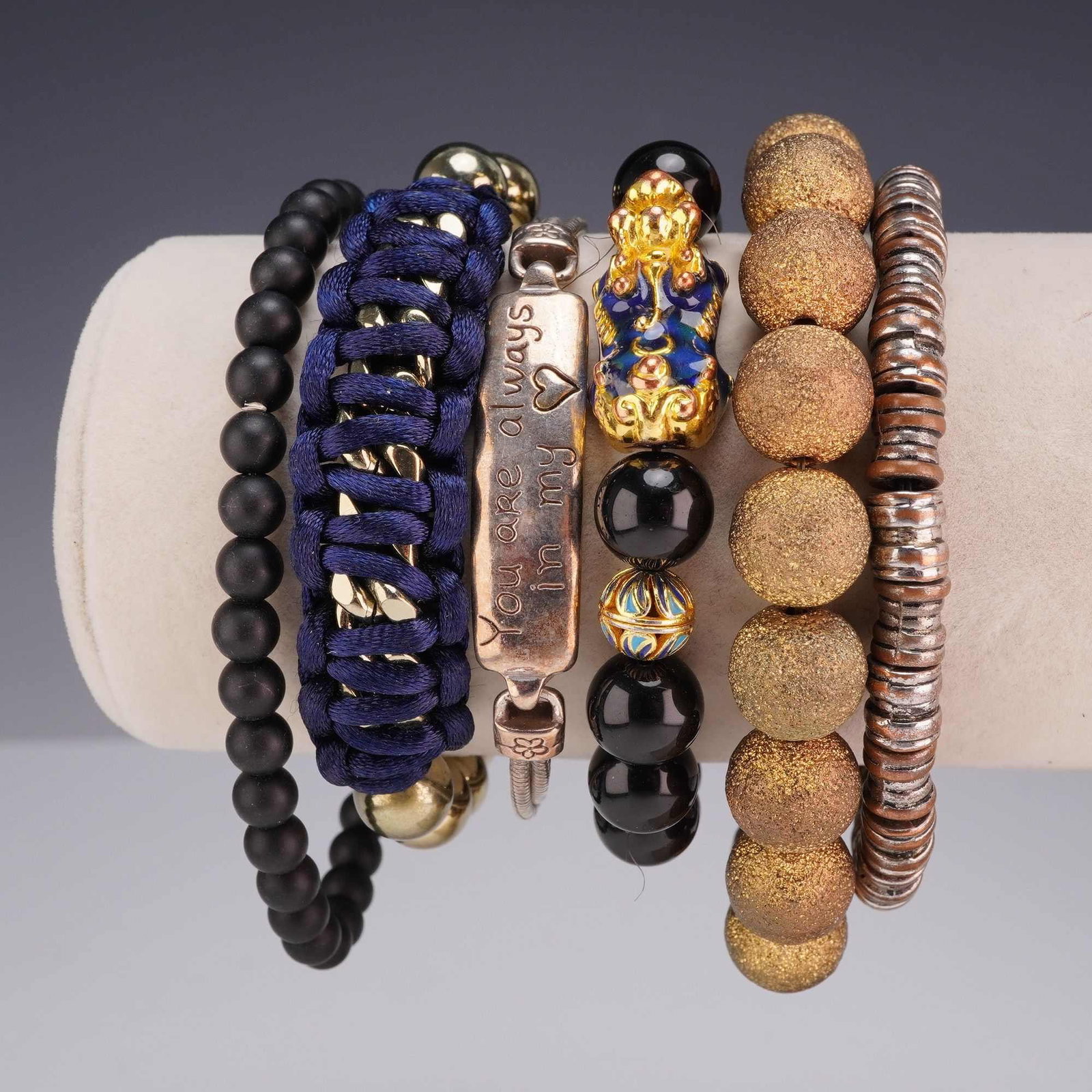 6pc Collection of Assorted Beaded and Fashion Bracelets Including Brighton: An assortment of six fashion bracelets featuring a variety of materials and designs. The collection includes a silver-tone multi-strand snake chain bracelet by Brighton, featuring a central rectangula
