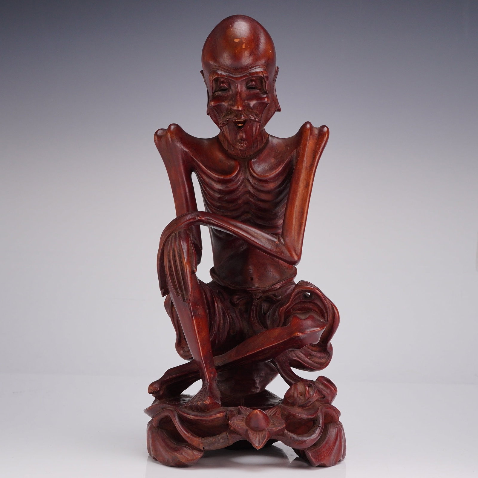 Chinese Emaciated Ascetic Shakyamuni Buddha Hardwood Sculpture: A Chinese hardwood carving, depicting an emaciated male figure. This subject matter represents Shakyamuni Buddha during his six years of extreme asceticism prior to achieving enlightenment, although