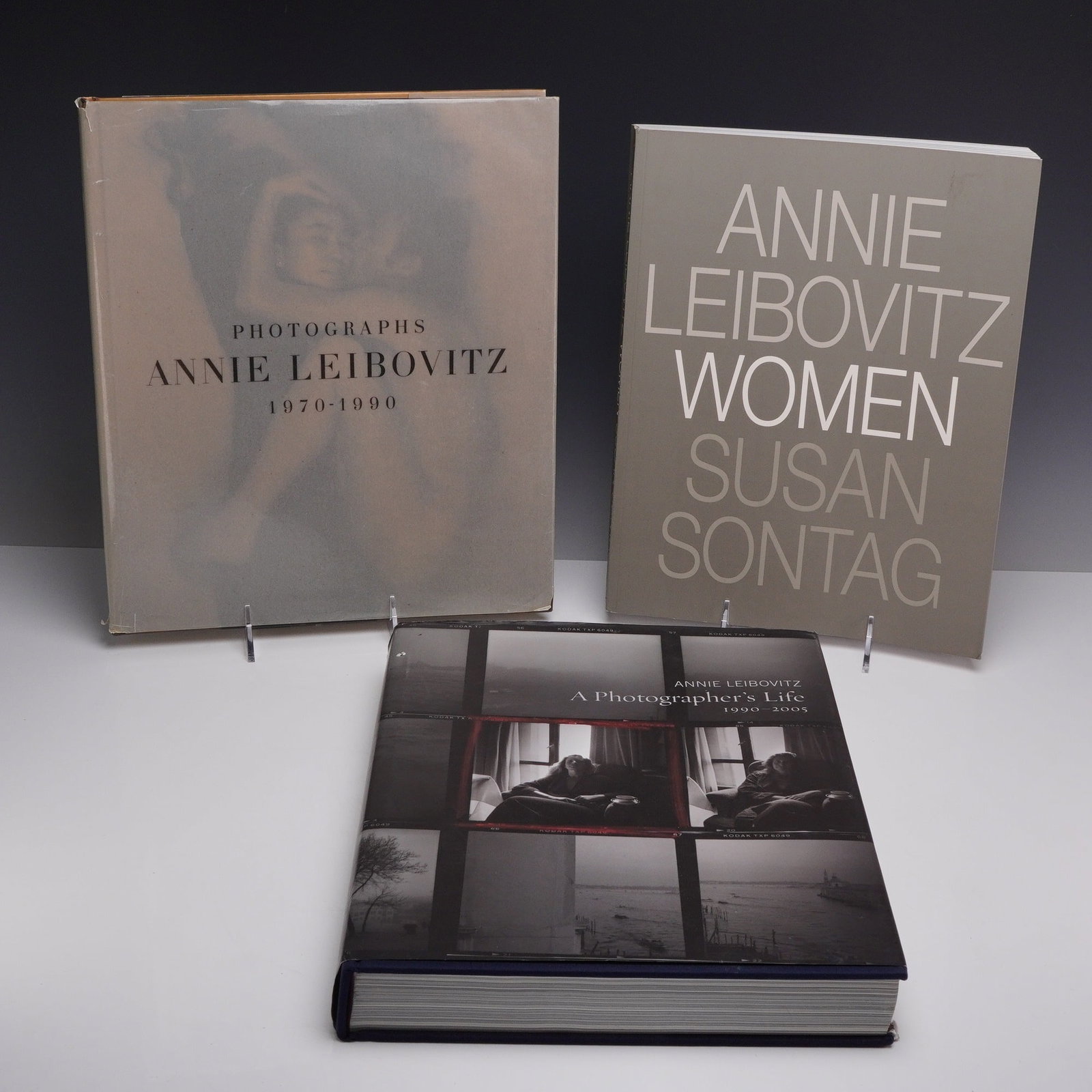 Leibovitz, Annie. Three Volumes: Photographs 1970-1990, Women, and A Photographer's Life. 1991-2006.: A collection of three large-format photography volumes by Annie Leibovitz, all published by Random House. The group includes: Photographs: Annie Leibovitz 1970-1990, featuring a translucent matte dust