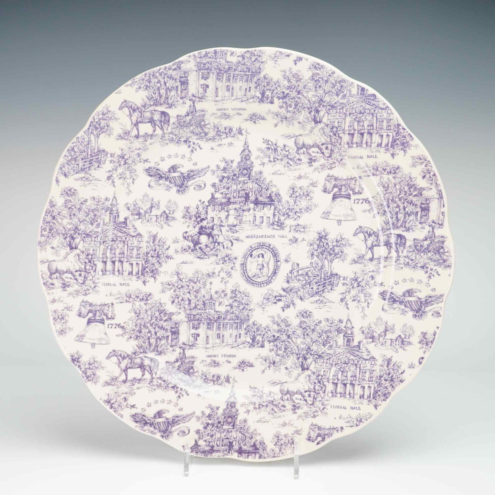 American Historical Motif Mulberry Transferware Charger: This large ironstone charger features a scalloped rim and is decorated with monochrome mulberry transfer-printed vignettes of American historical significance. The center of the plate displays the