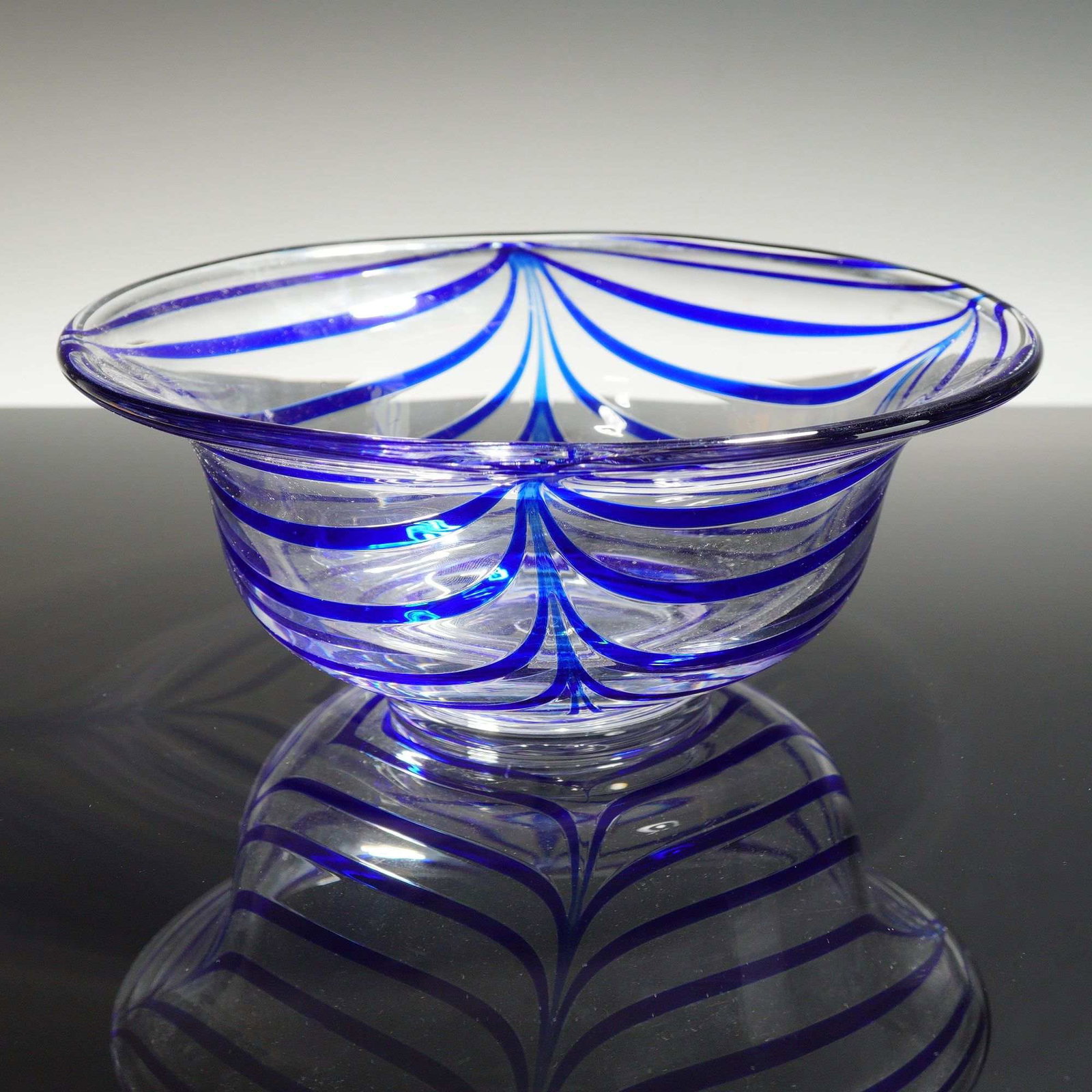 Metropolitan Museum of Art Glass Bowl: This hand-blown art glass bowl was produced for the Metropolitan Museum of Art (MMA). The piece features a classic festooned or pulled-thread technique, where vibrant cobalt blue glass threads were