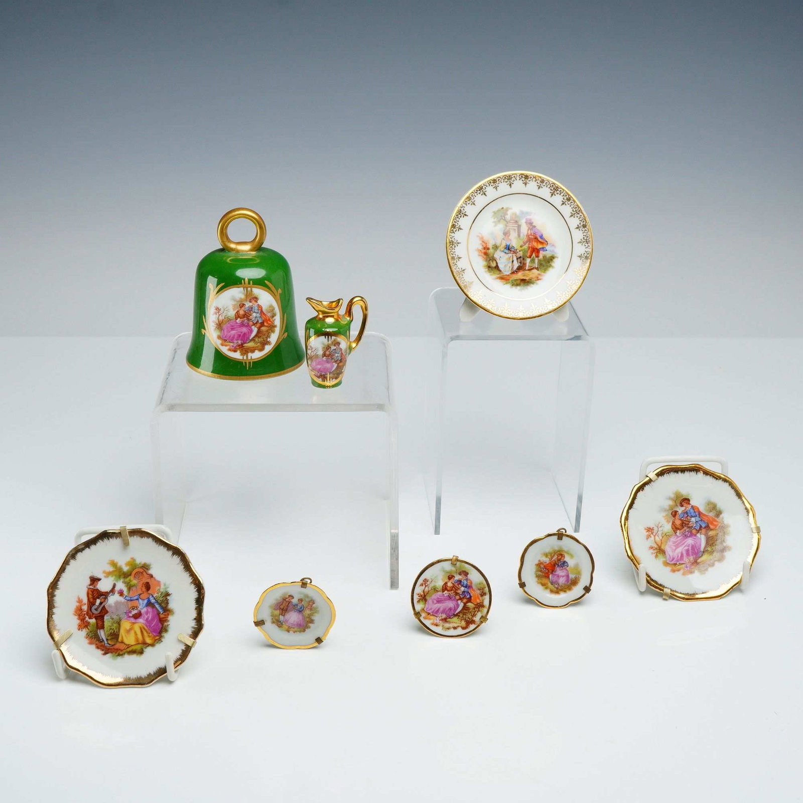 8pc Limoges France Porcelain Miniature Collection with Bell and Pitcher: This collection includes eight pieces of miniature Limoges porcelain, featuring a variety of forms decorated with romantic scenes in the Fragonard style. The set is comprised of one bell, one miniatur