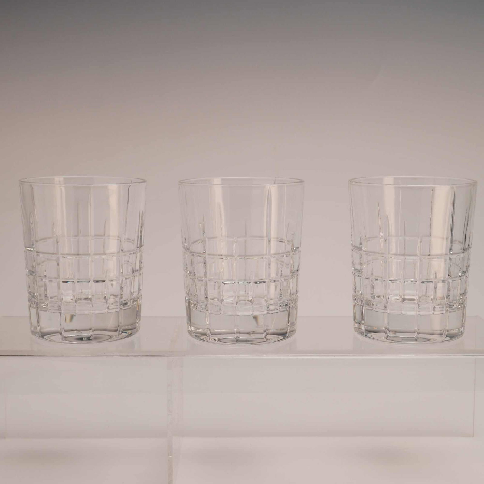 3pc Ralph Lauren Crystal Double Old Fashioned Glasses: A lot of three whiskey tumblers or double old fashioned glasses produced by Ralph Lauren. The glasses are crafted from heavy, high-leaded crystal characterized by high clarity and light refraction. Th
