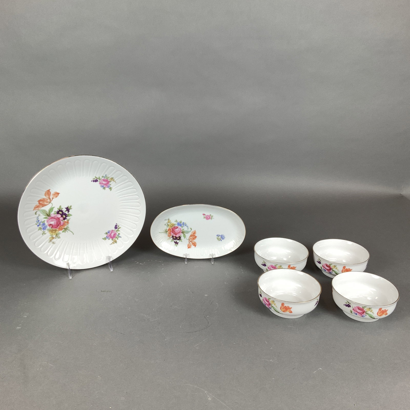 6pc Henneberg Porcelain Floral Dinnerware Set: This is a six-piece set of white porcelain tableware produced by Henneberg Porzellan in the German Democratic Republic. The collection is decorated in a traditional German floral style featuring multi