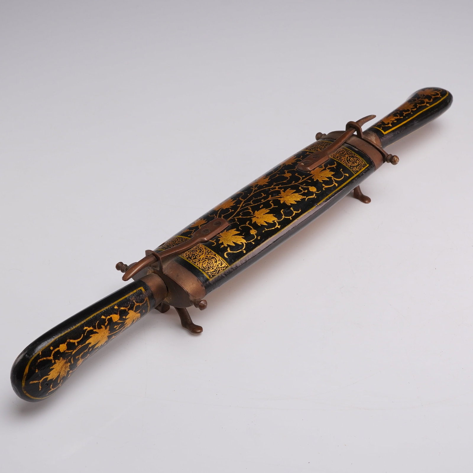 A Three-Piece Asian Carving Set with Knife, Trident-Style Fork, and Lacquered Wood Scabbard Stand: This vintage three-piece carving set is an example of mid-20th-century Indian metalware produced for the export market. The set includes a curved carving knife, a matching two-tine fork often referred