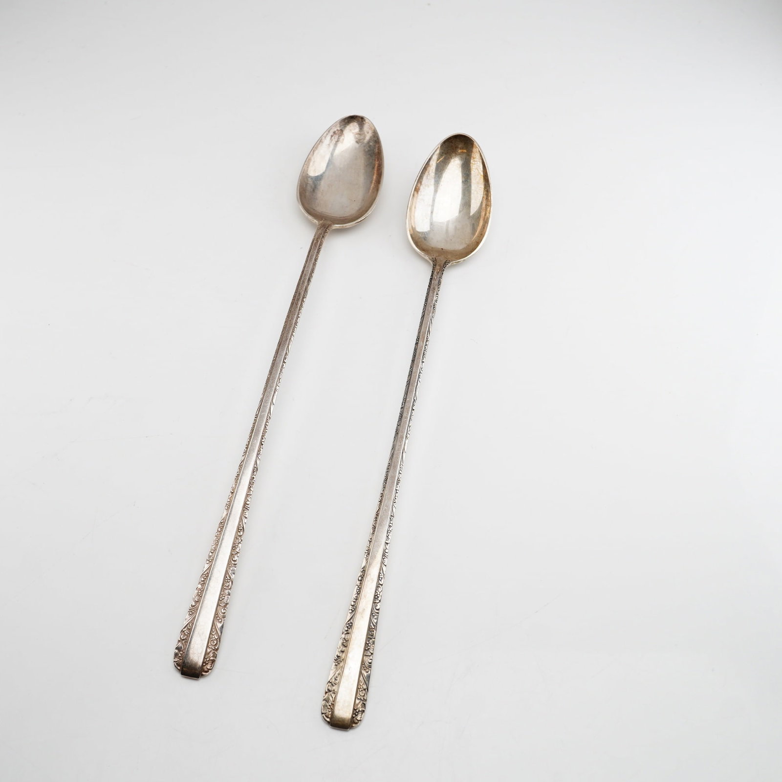 2pc Towle Candlelight Sterling Silver Iced Tea Spoons: Two solid sterling silver iced tea spoons in the Candlelight pattern by Towle Silversmiths. The pattern, first introduced in 1934, features a flared handle decorated with a delicate border of stylized